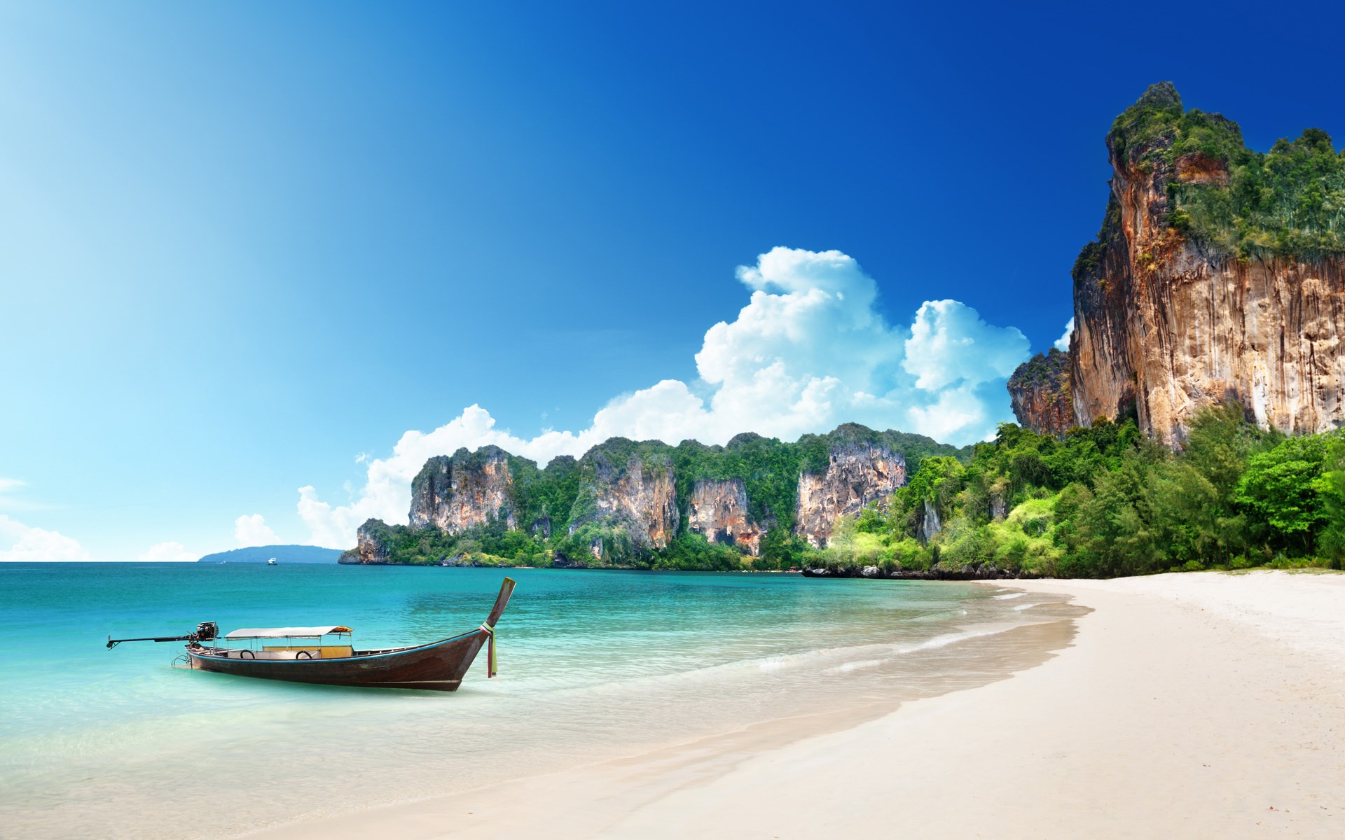 Longtail boat on a tropical beach with limestone cliffs HD Wallpaper