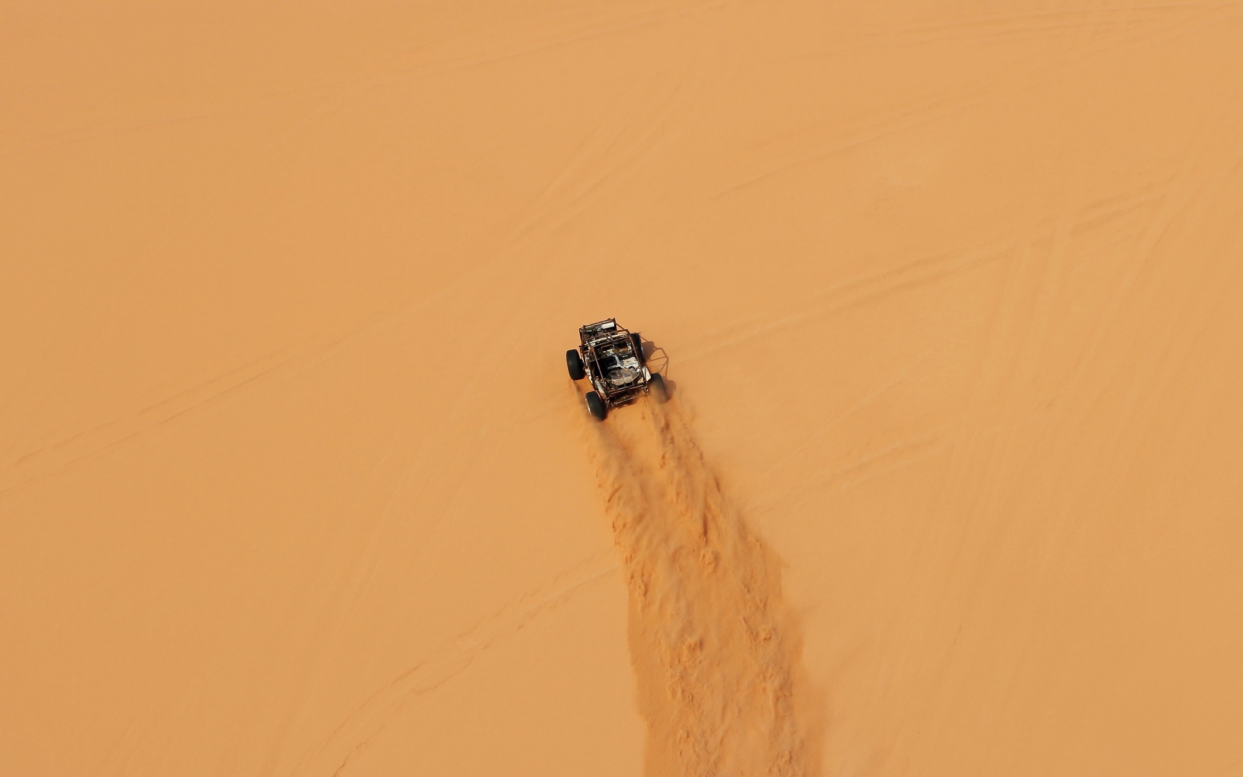 Buggy driving through sand dunes HD Wallpaper