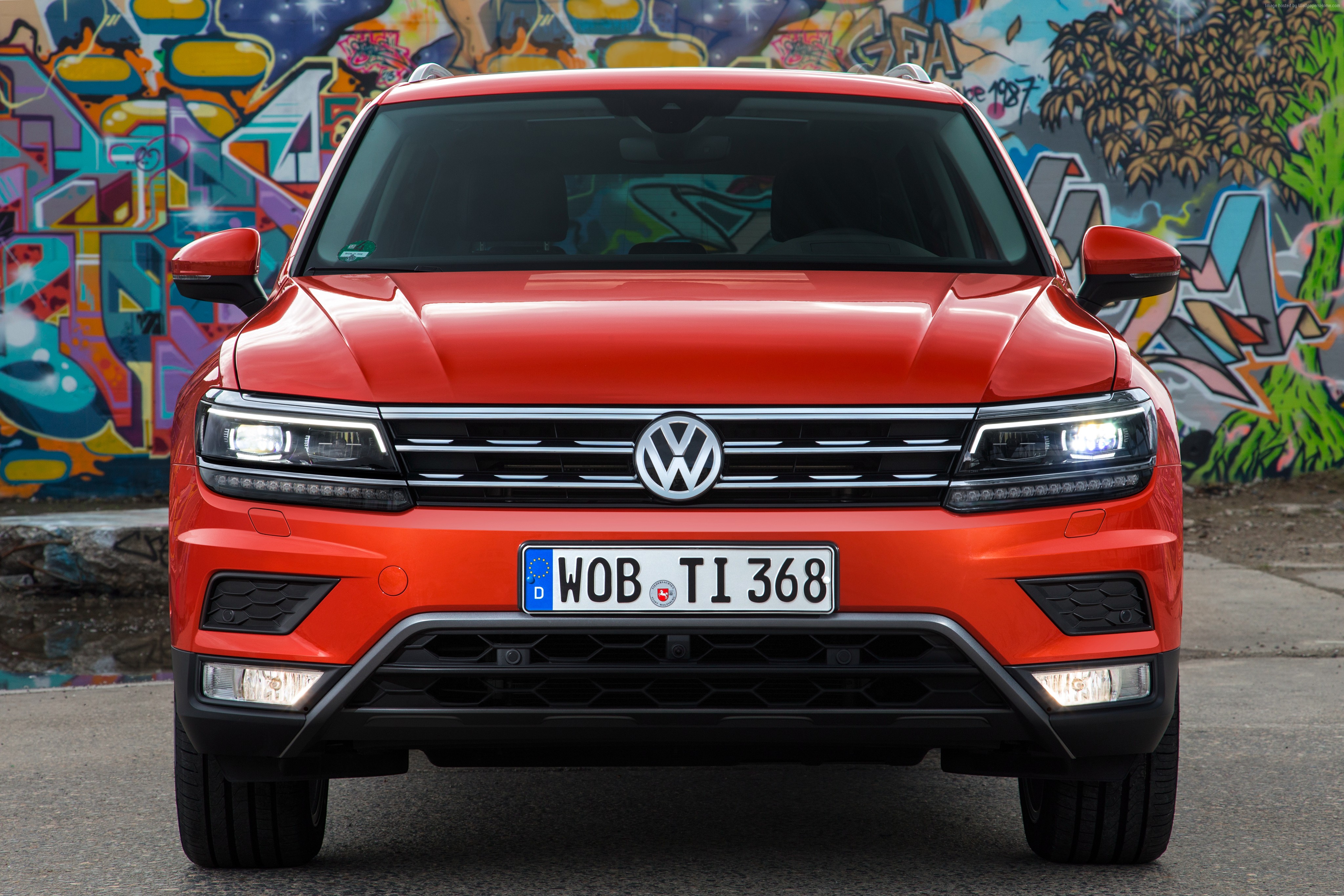Orange Volkswagen Tiguan parked in front of graffiti wall HD Wallpaper
