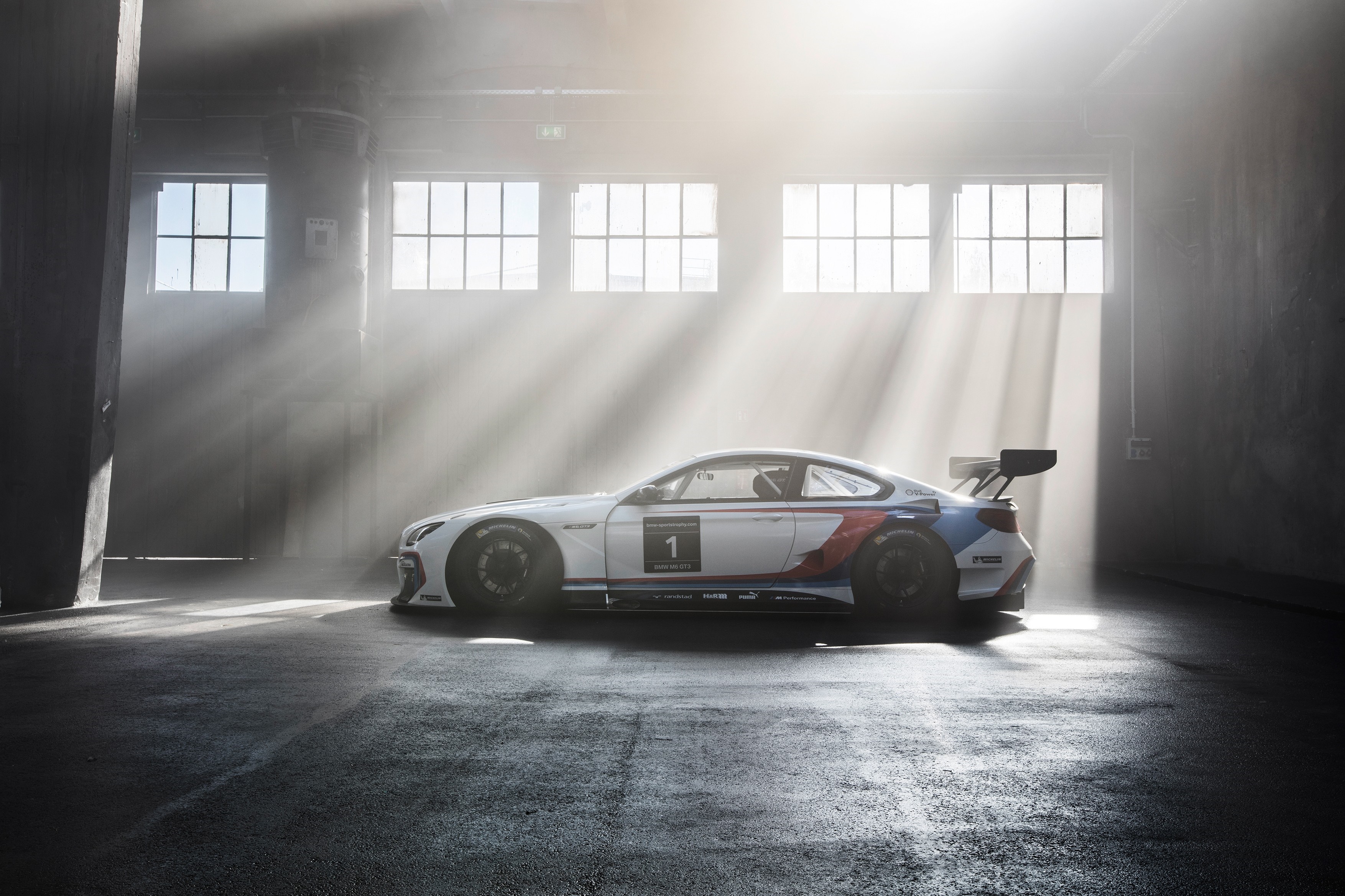 BMW M6 GT3 race car in a warehouse HD Wallpaper