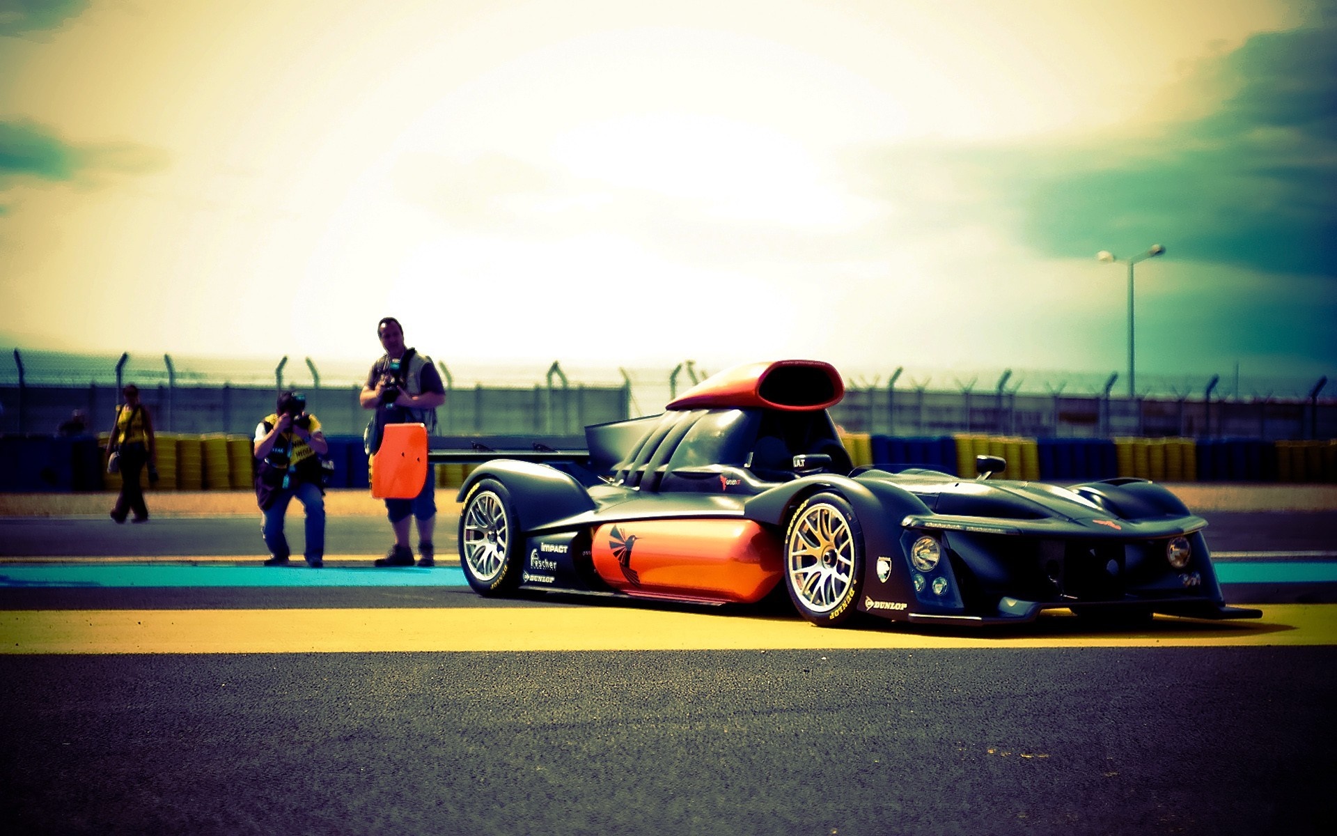 Race car on a track with photographers HD Wallpaper