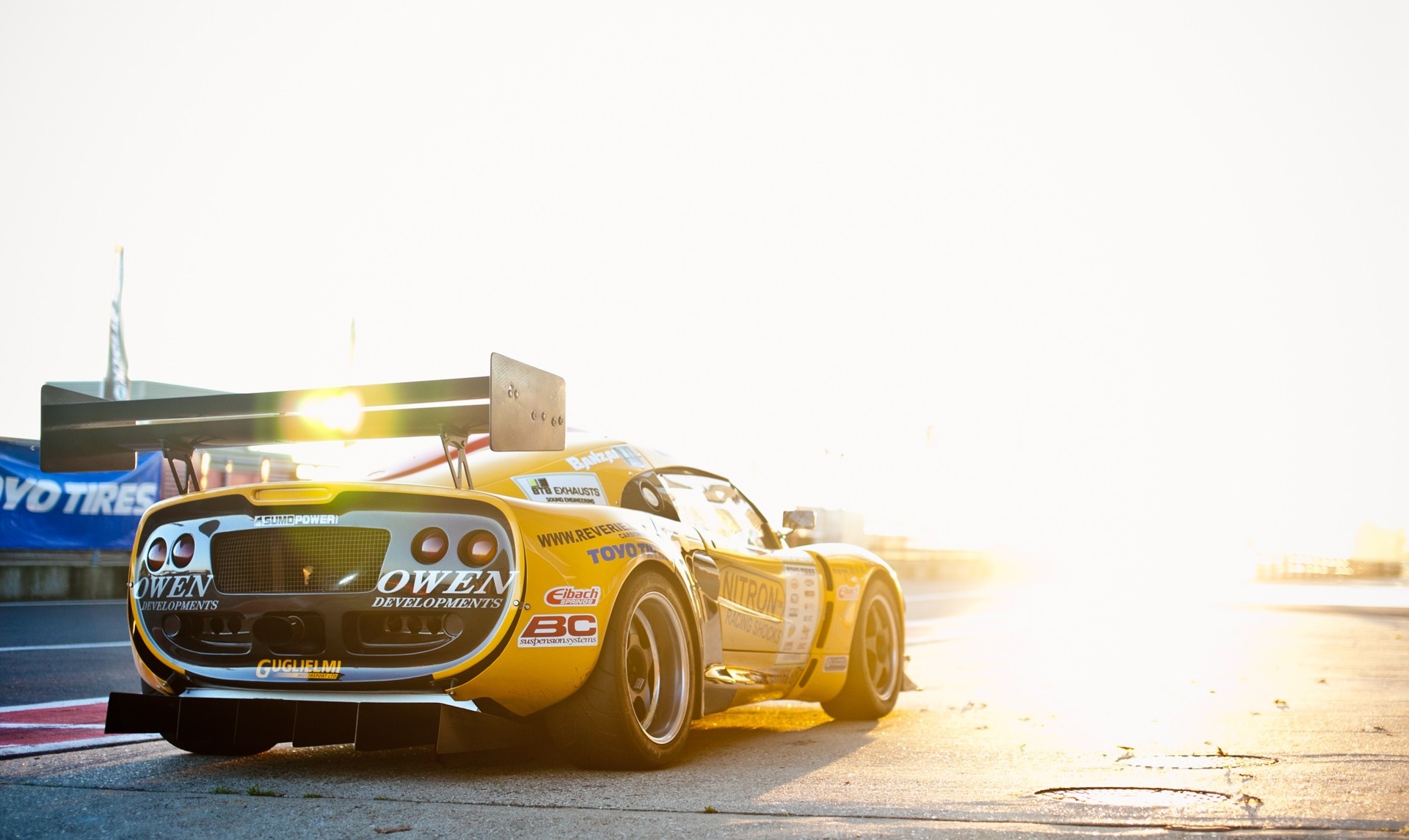 Yellow Owen Developments race car with large rear wing HD Wallpaper