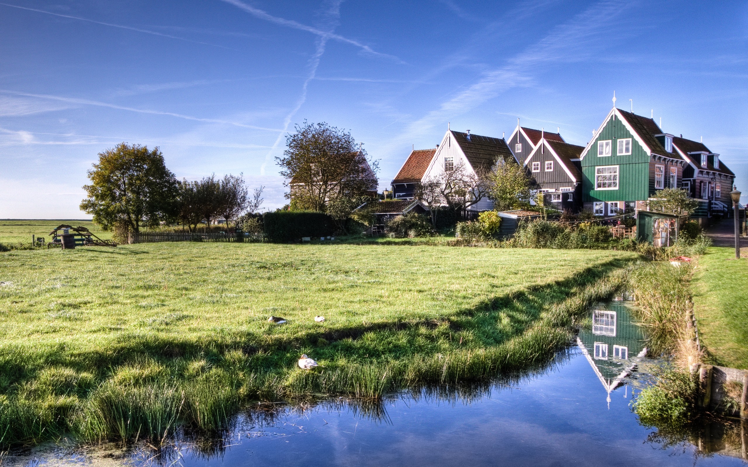 Rural village with houses and a canal HD Wallpaper
