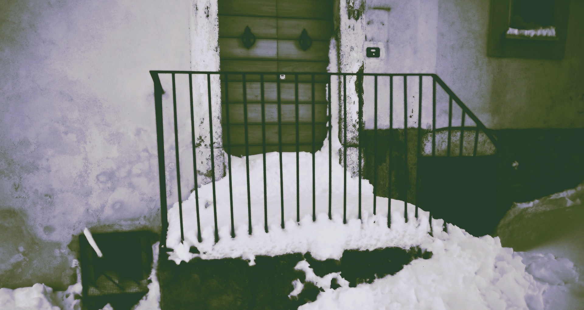 Snow covered railing in front of a wooden door HD Wallpaper