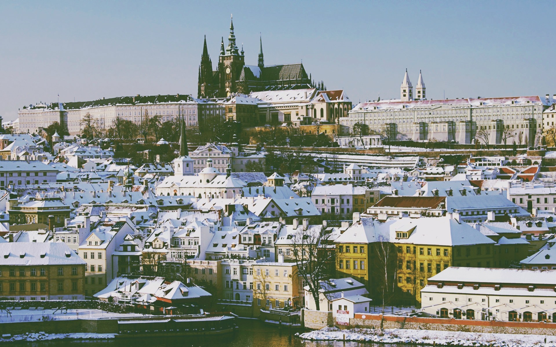 Prague cityscape with snow-covered roofs and castle HD Wallpaper