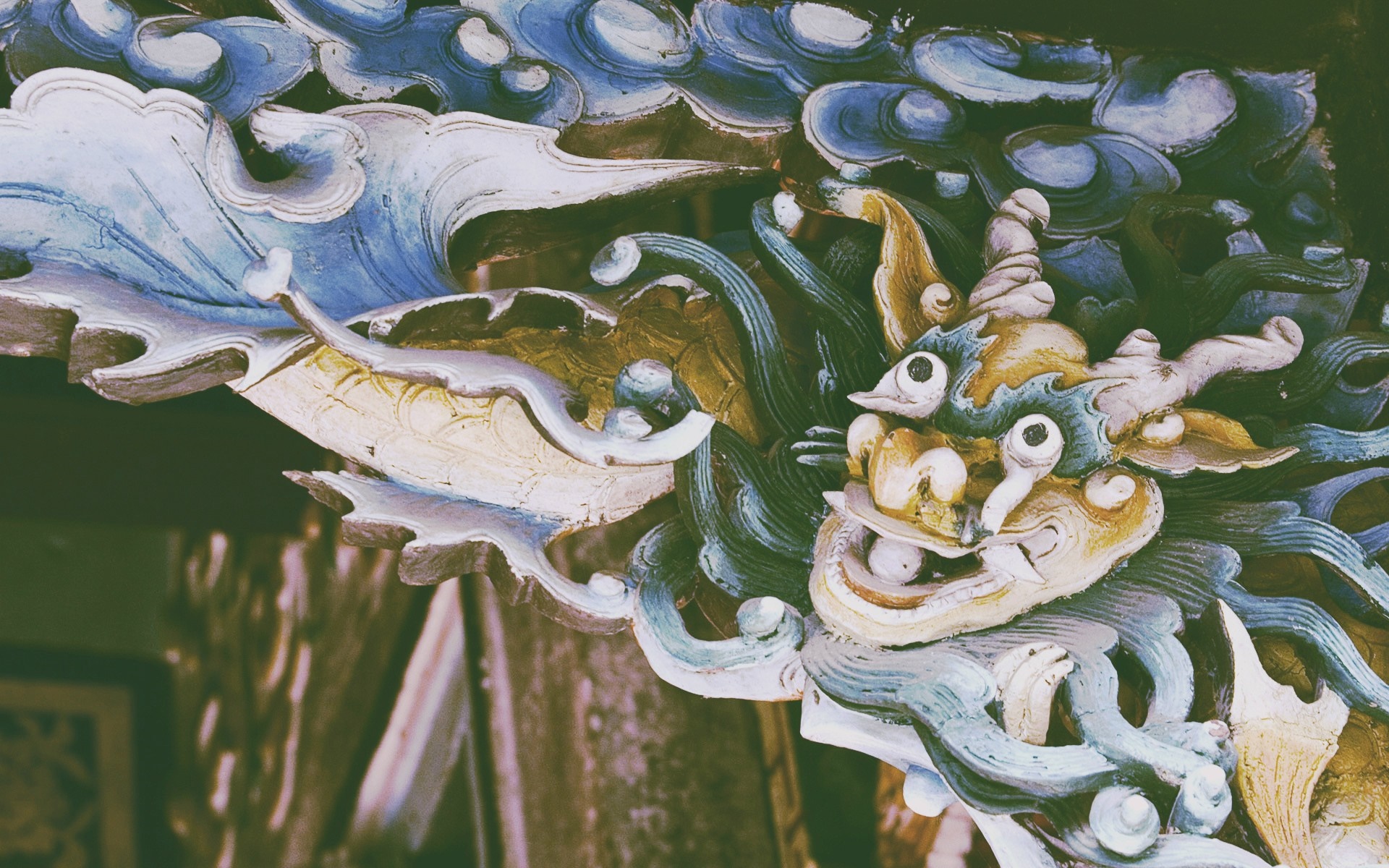 Close-up of a colorful dragon carving with blue and white waves HD Wallpaper