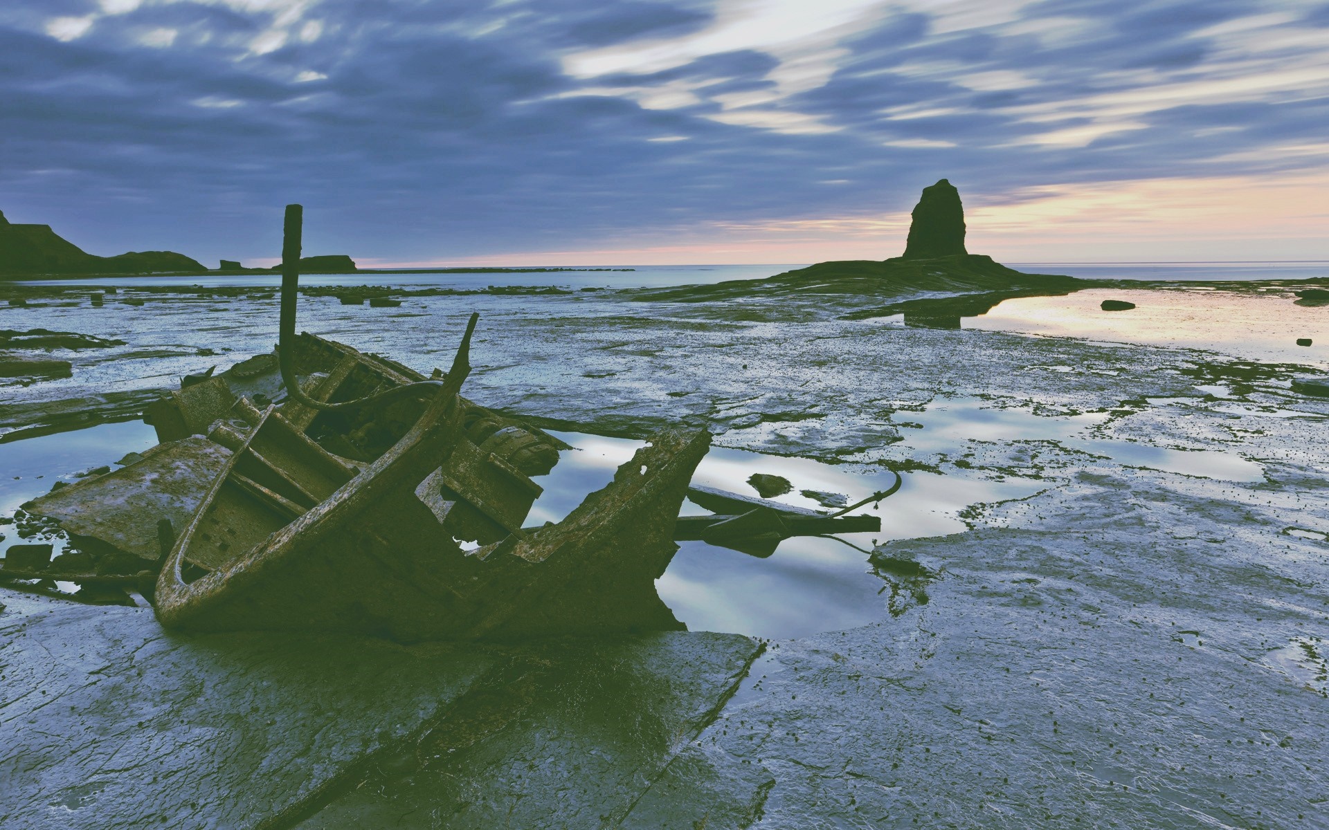 Shipwreck on a rocky shore at sunset HD Wallpaper