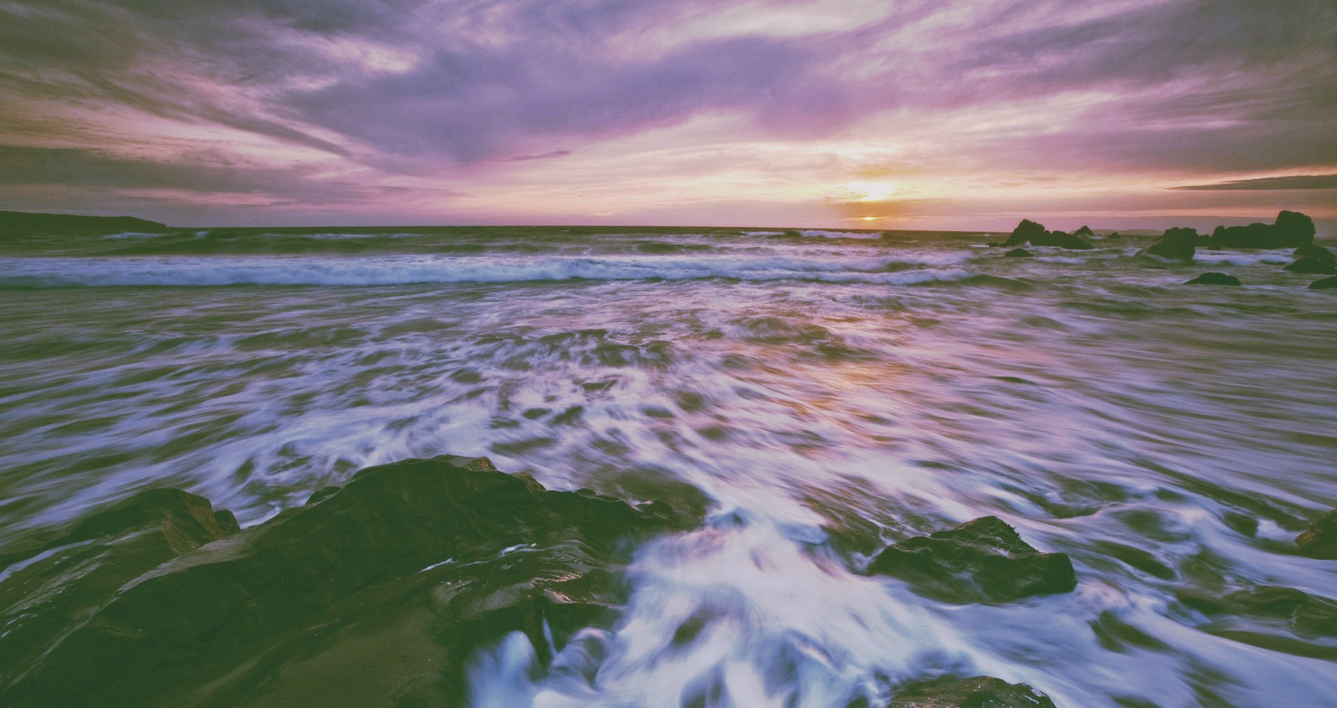 Sunset over the ocean with waves and rocks HD Wallpaper