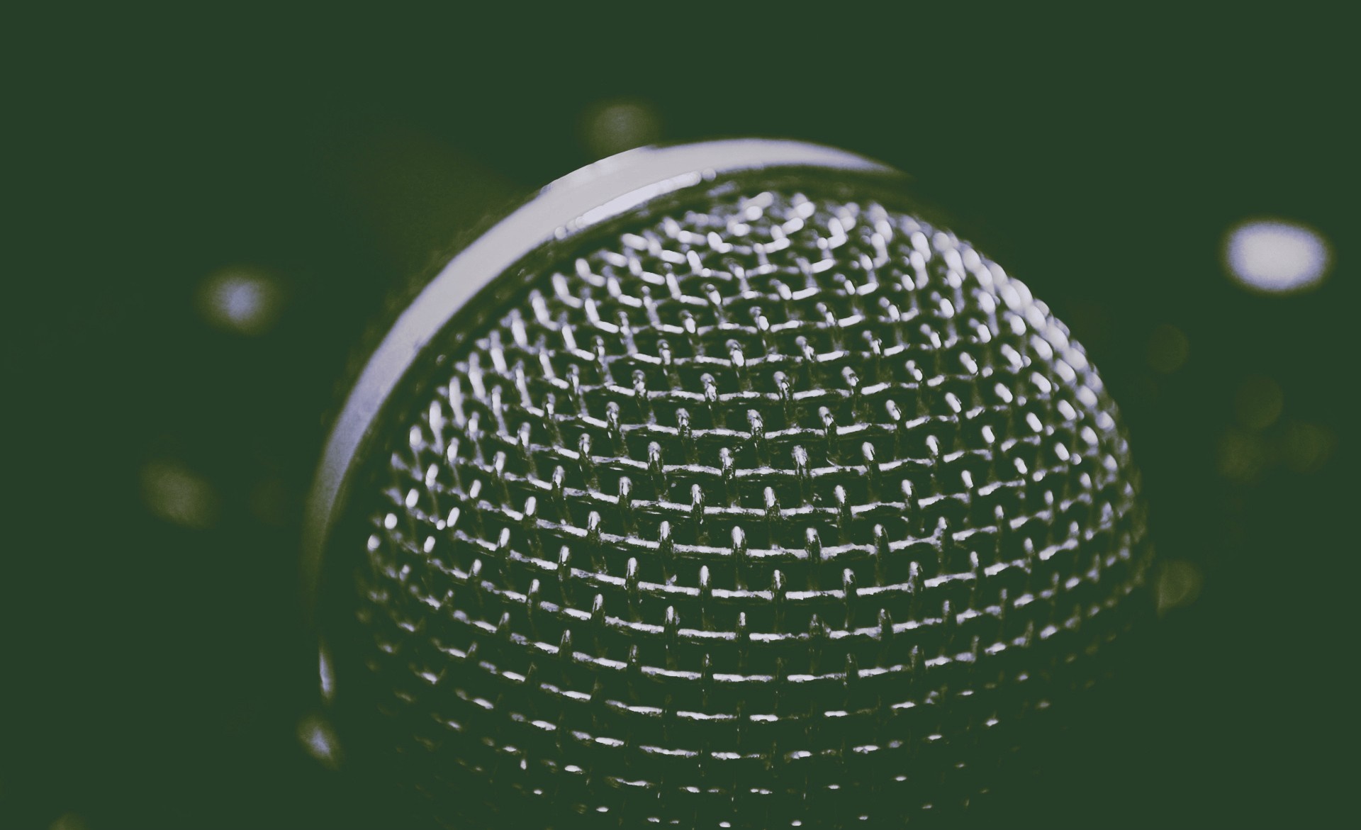 Close-up of a microphone grill with water droplets HD Wallpaper