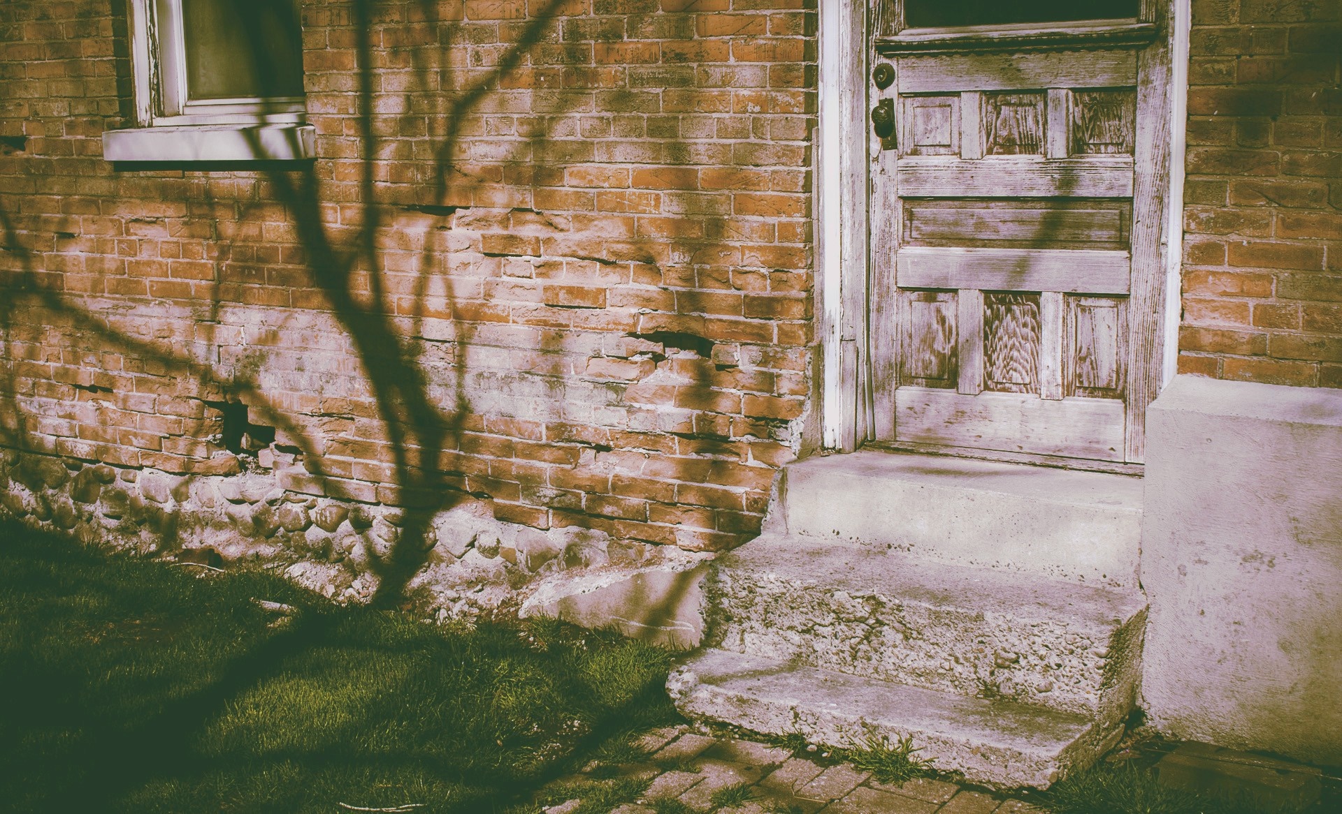 Old brick house with a weathered door and window HD Wallpaper