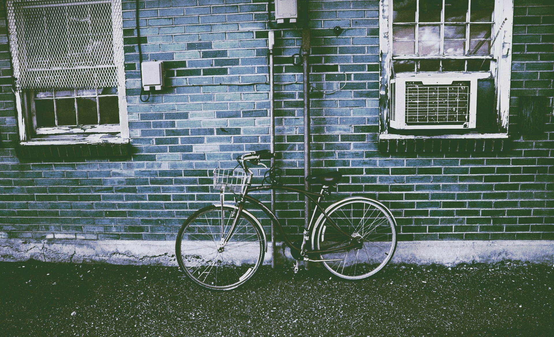 Bicycle parked against a brick wall with windows HD Wallpaper