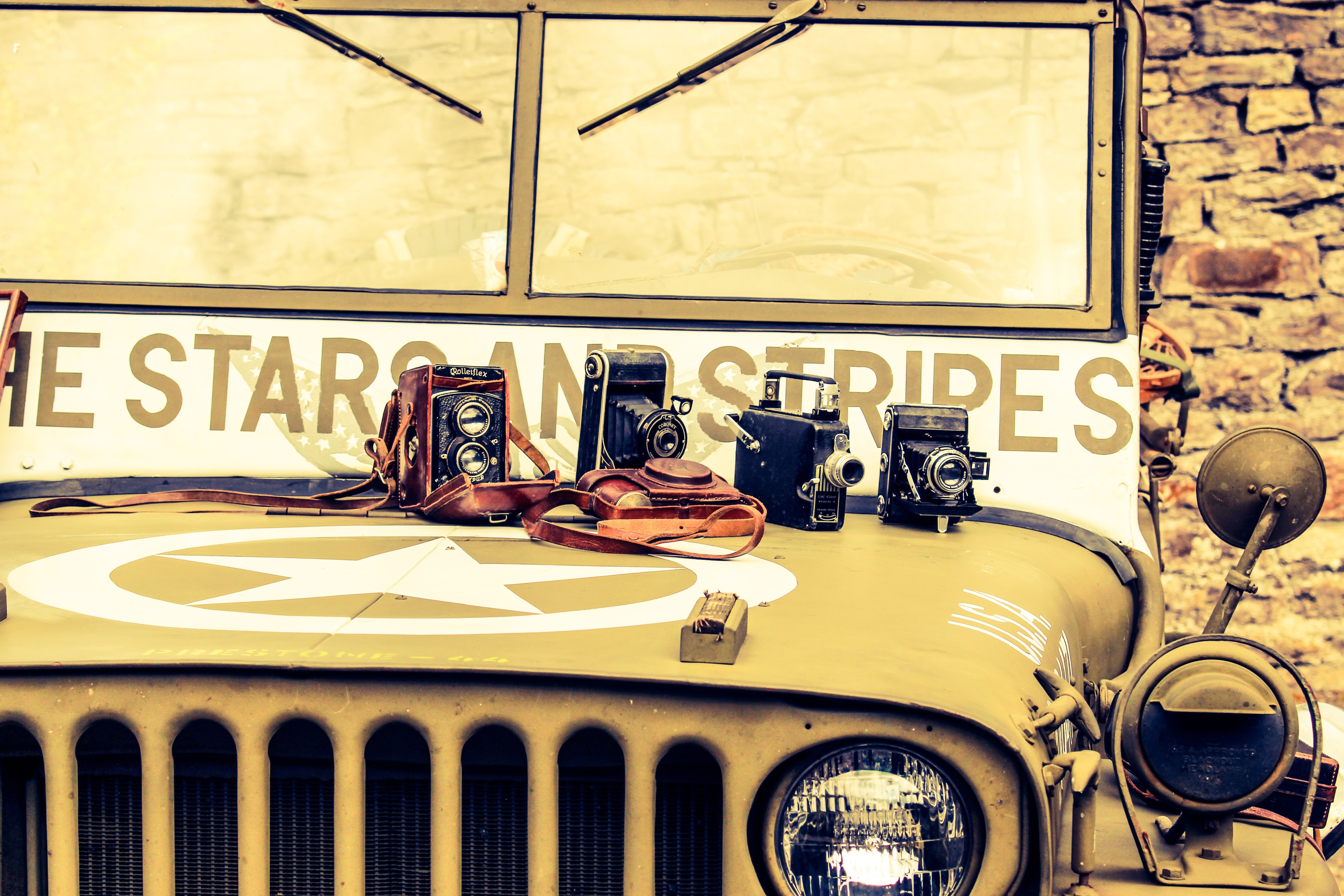 Vintage Jeep with antique cameras and "The Star and Stripes" text HD Wallpaper