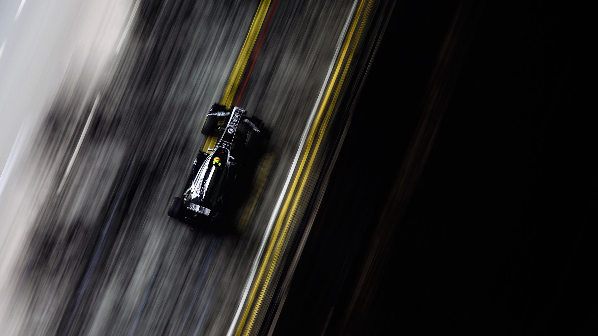 Formula 1 race car on track with motion blur HD Wallpaper