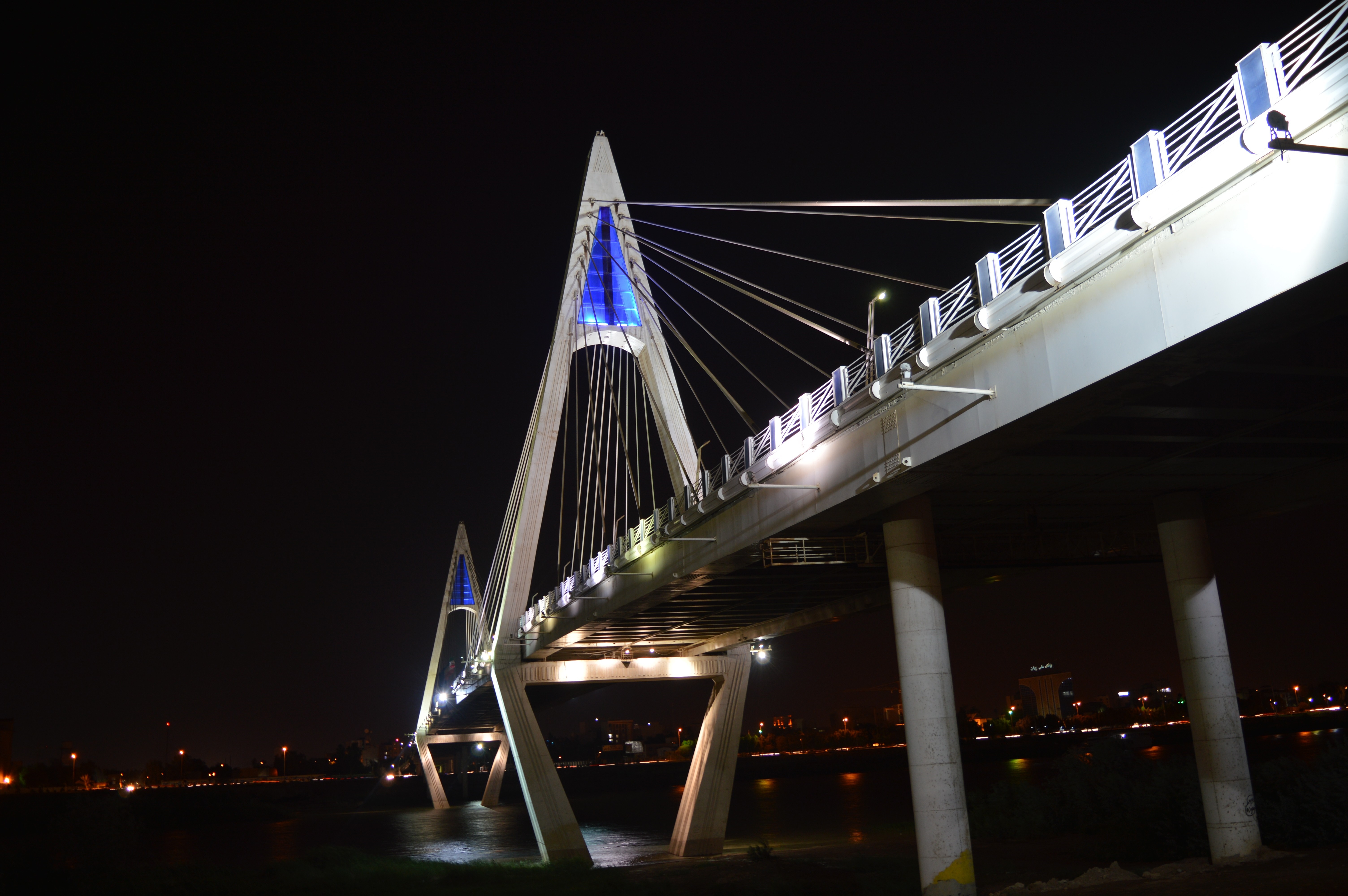 Modern cable-stayed bridge illuminated at night HD Wallpaper