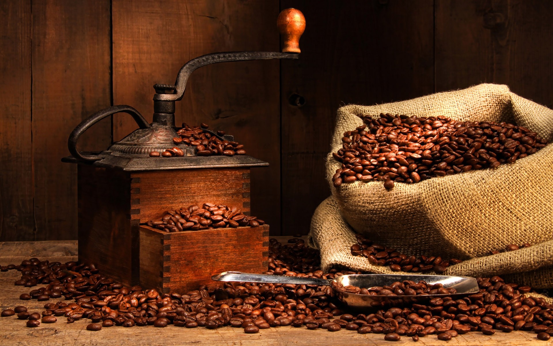 Coffee beans and grinder on a wooden surface HD Wallpaper
