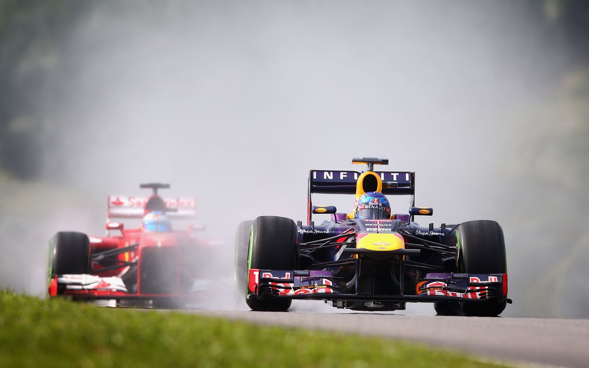 Formula 1 race cars on a wet track HD Wallpaper
