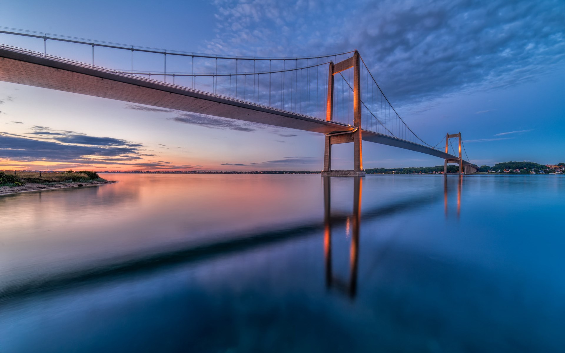 Suspension bridge over water at sunset HD Wallpaper