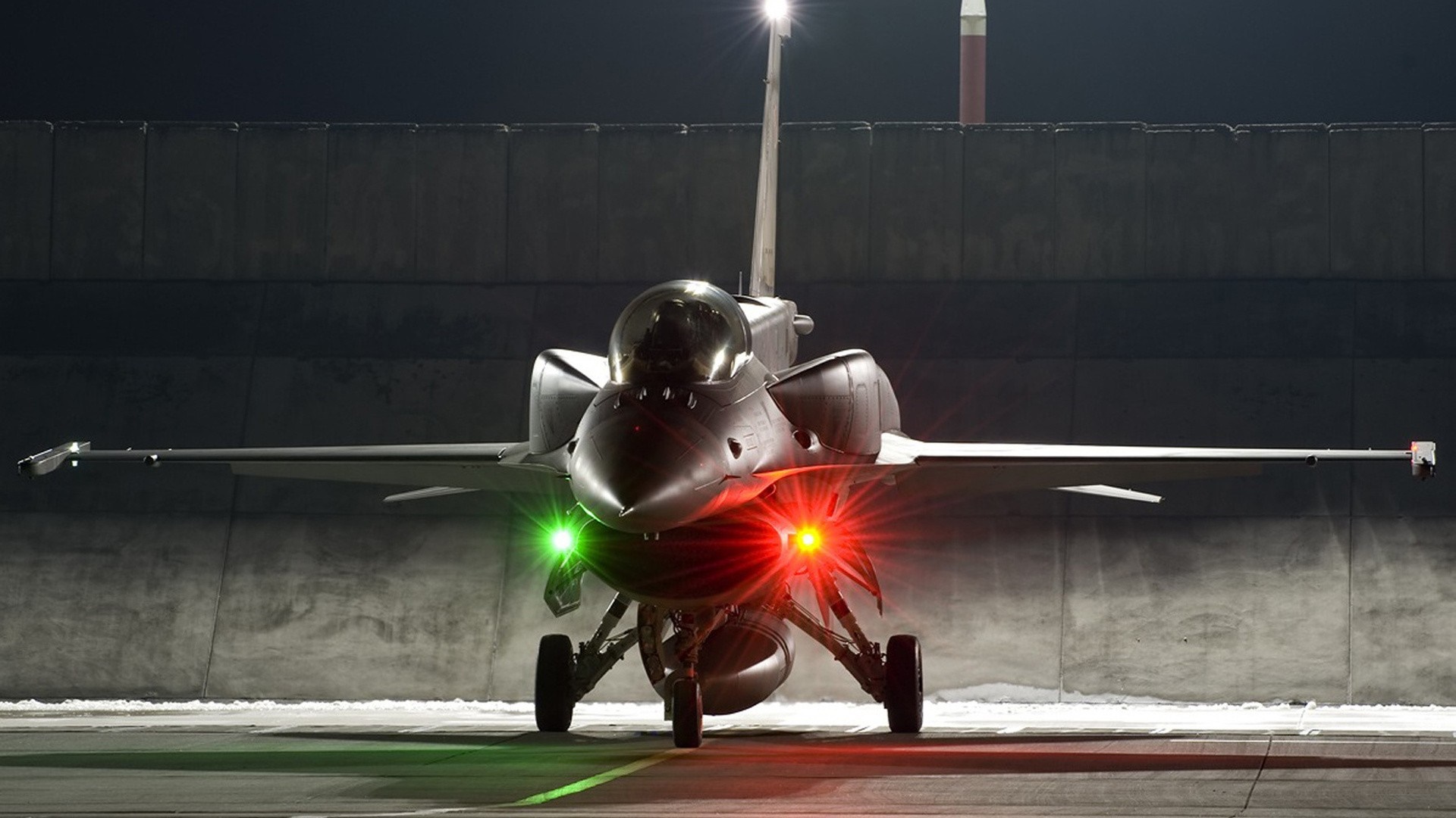 F-16 Fighting Falcon aircraft on tarmac at night HD Wallpaper