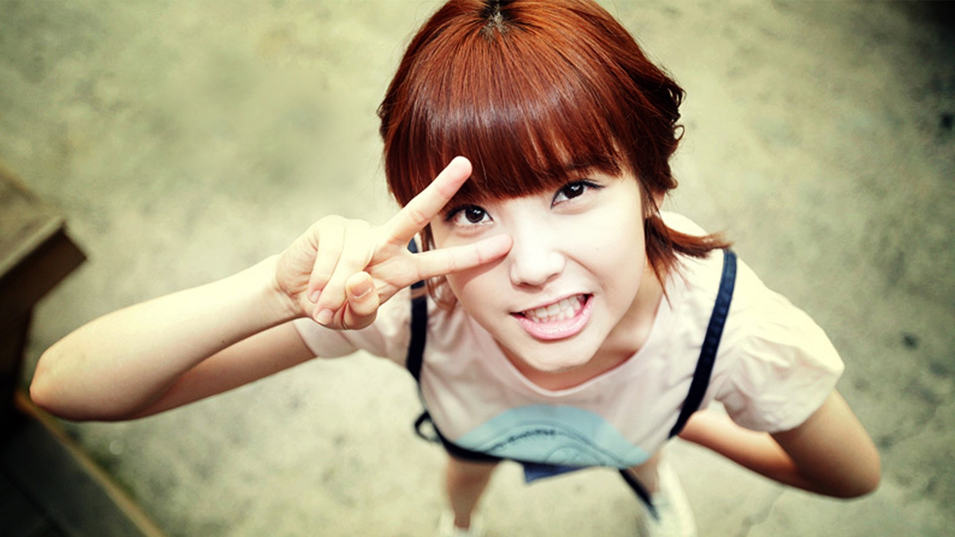 Young woman with red hair making peace sign HD Wallpaper