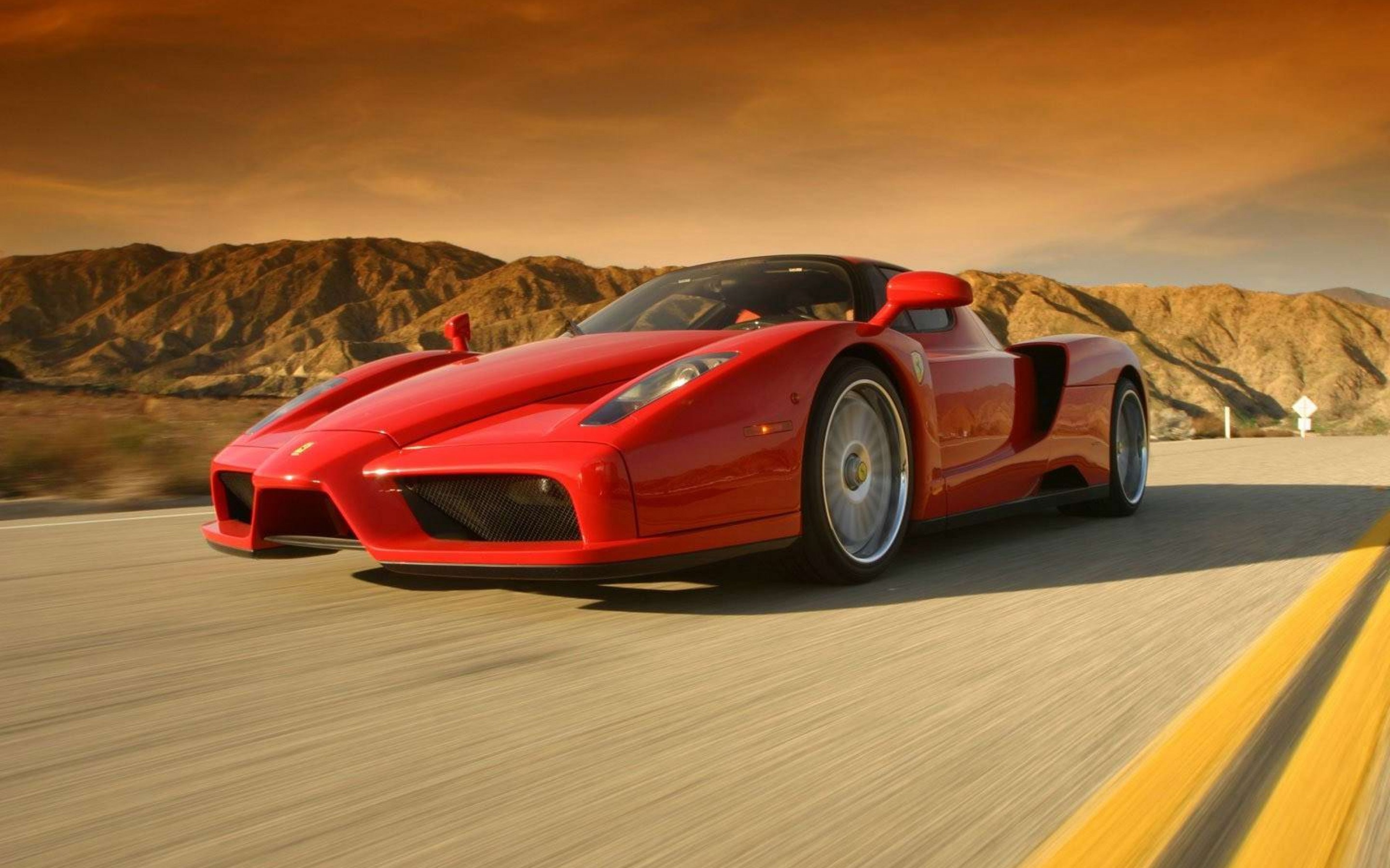 Red Ferrari Enzo driving on a desert road HD Wallpaper