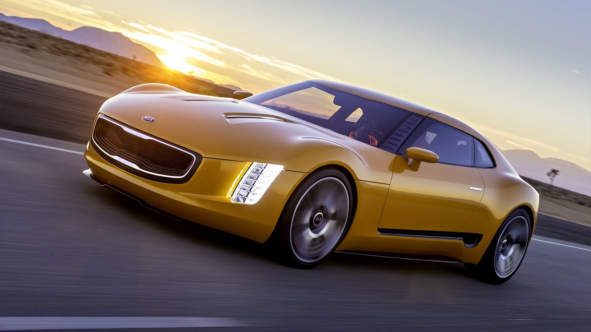 Yellow Kia GT4 Stinger Concept sports car driving on a road HD Wallpaper