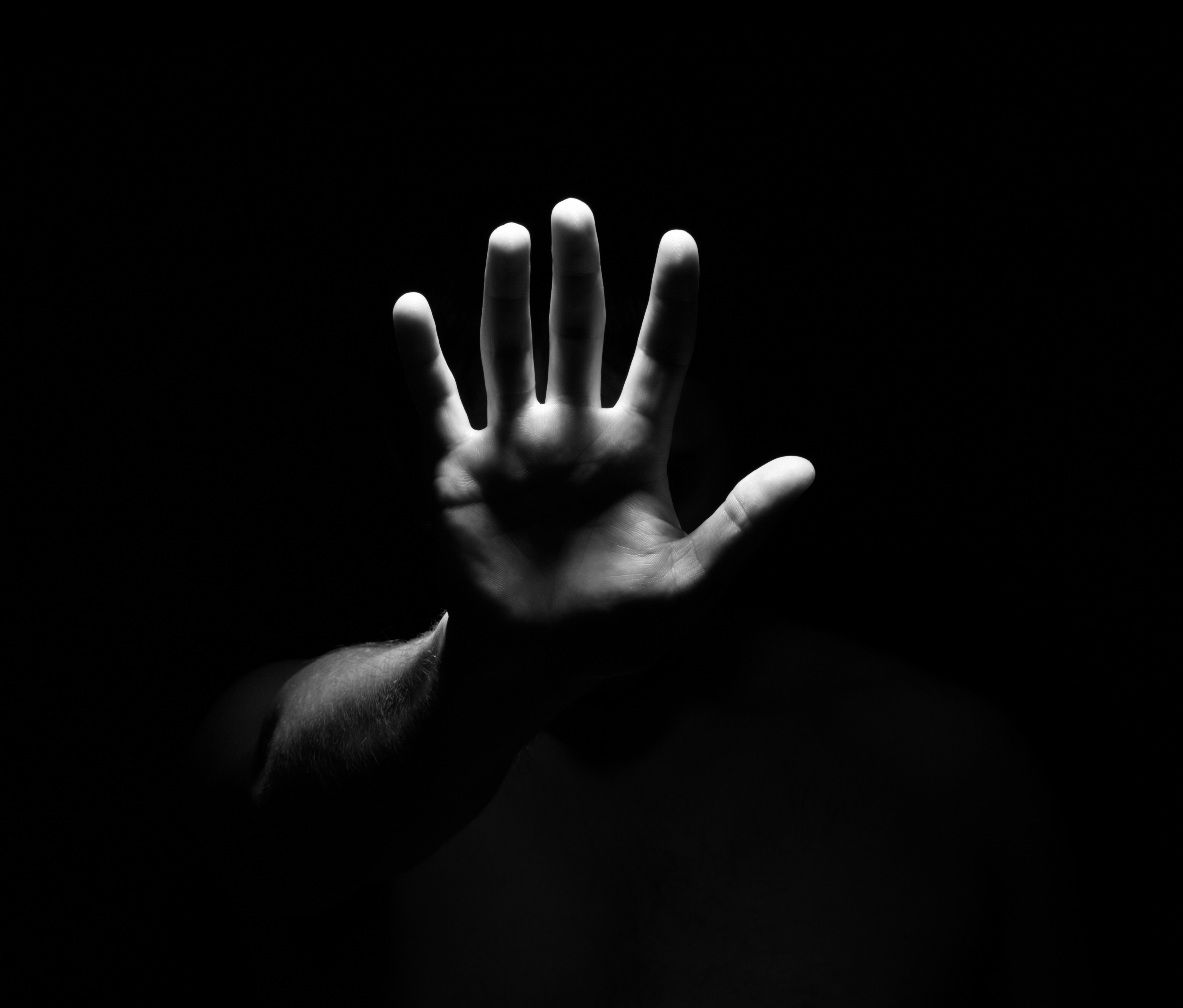 Monochrome close-up of a hand in darkness HD Wallpaper
