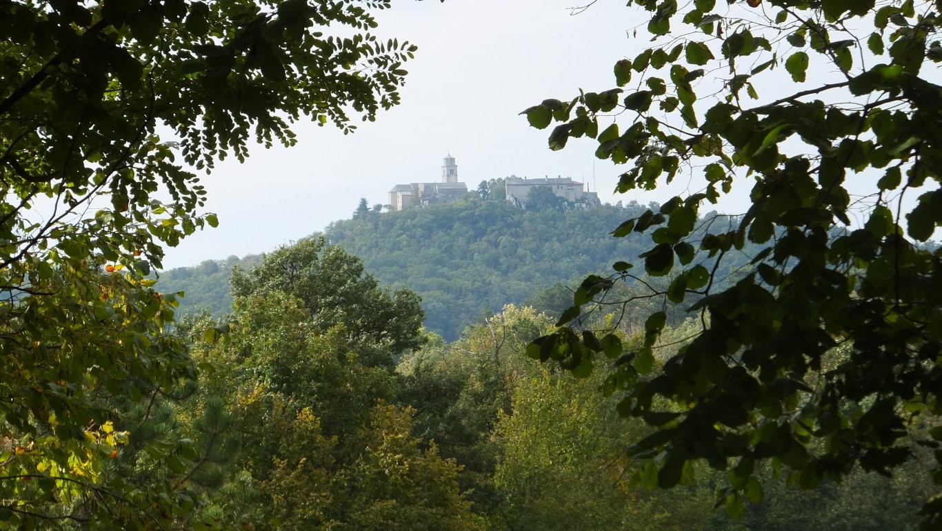 Sanctuary on a hill in Monrupino, Italy, seen through trees HD Wallpaper