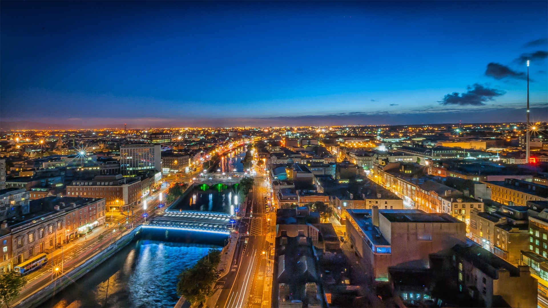 Cityscape at night with river and lights HD Wallpaper