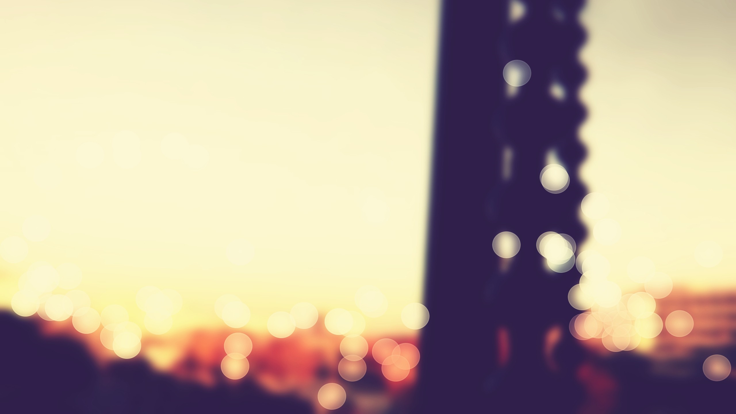 Bokeh lights and silhouette of a tower at sunset HD Wallpaper