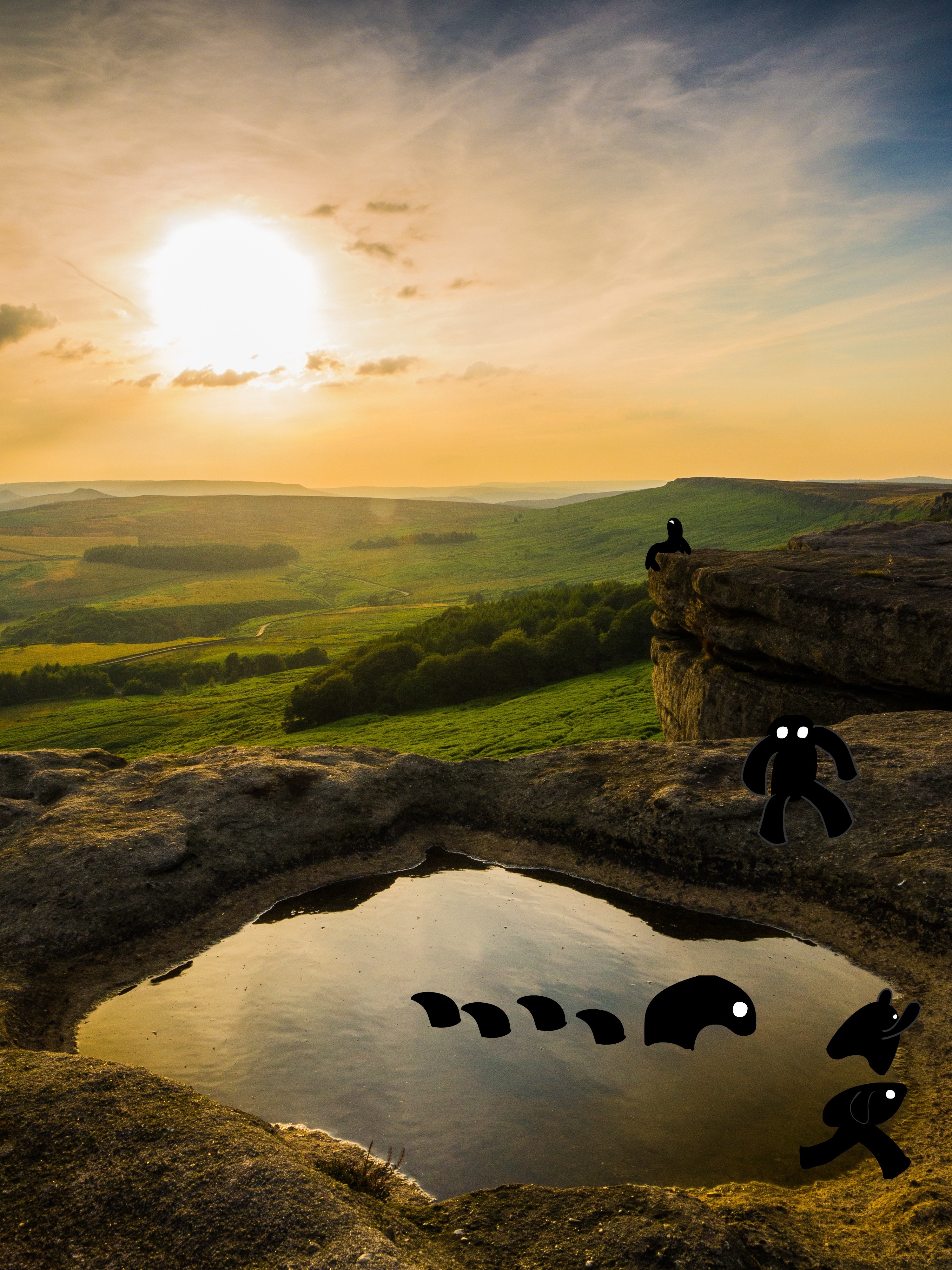 Black creatures in a rocky landscape at sunset HD Wallpaper