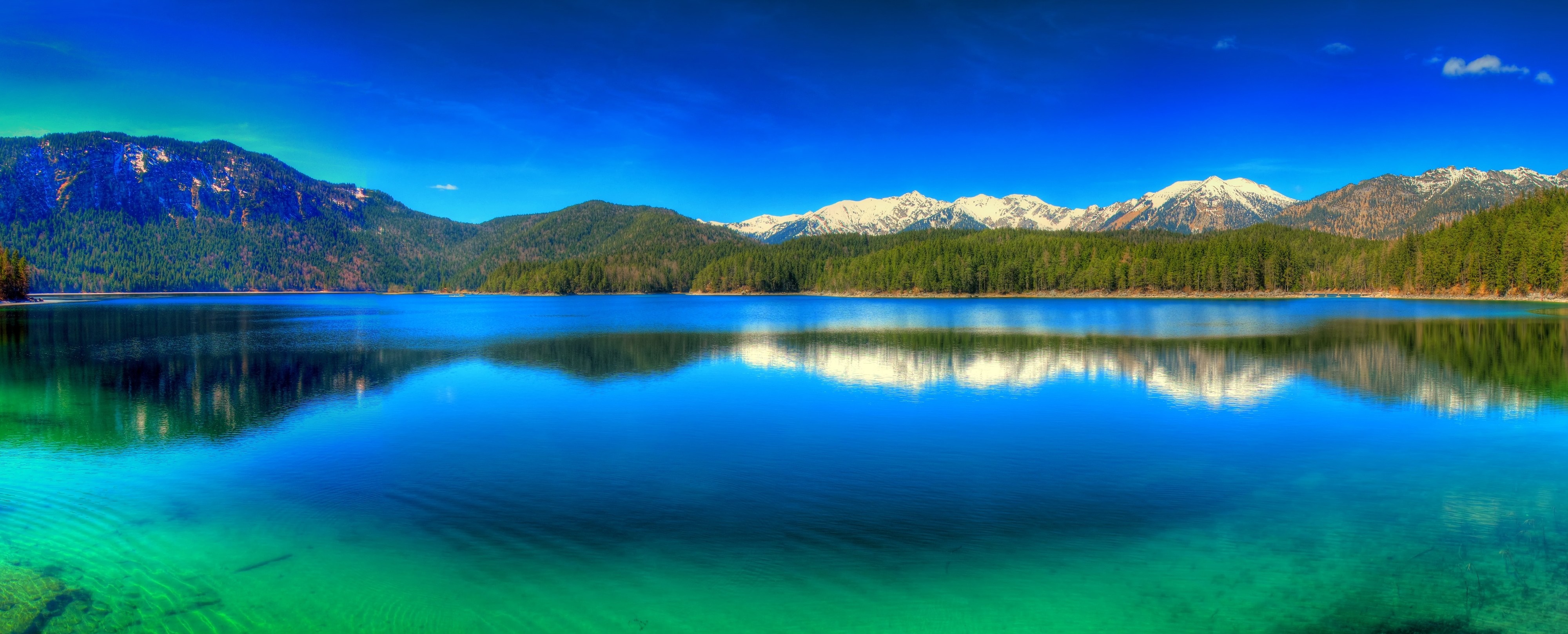 Panoramic view of a lake with mountains and forest HD Wallpaper