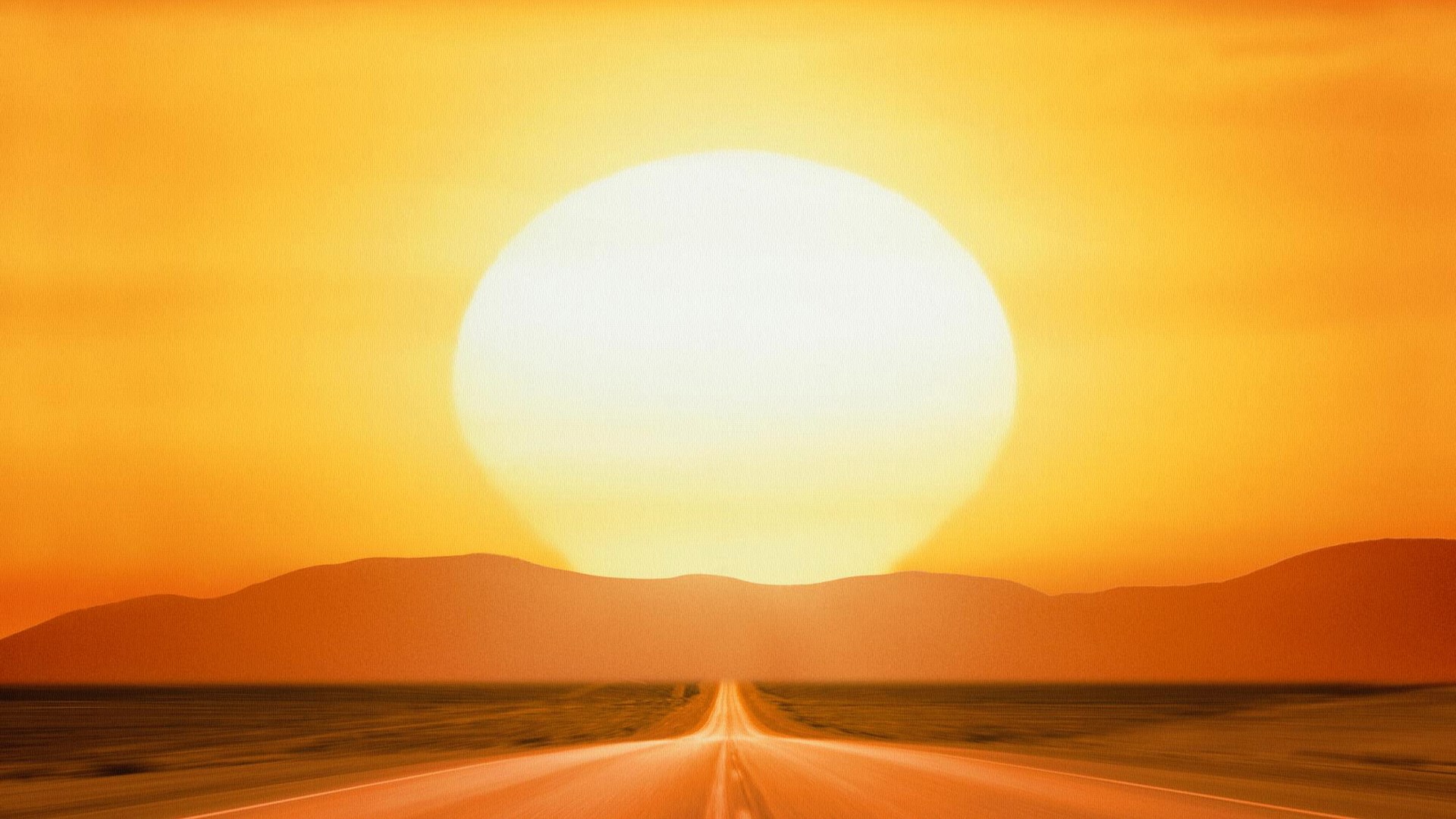 Road leading to mountains under a large sun HD Wallpaper