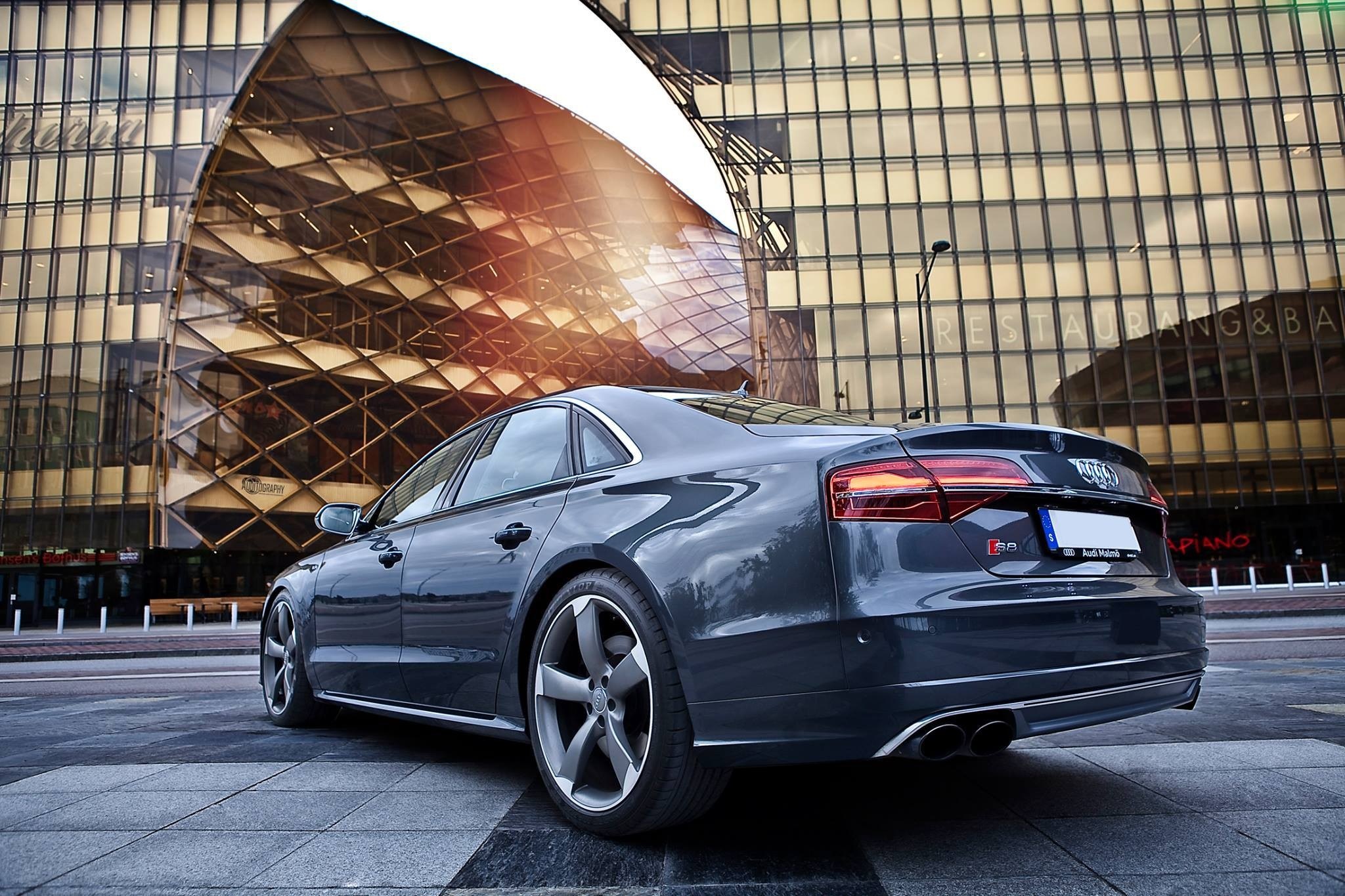 Dark gray Audi S8 parked in front of a modern building HD Wallpaper