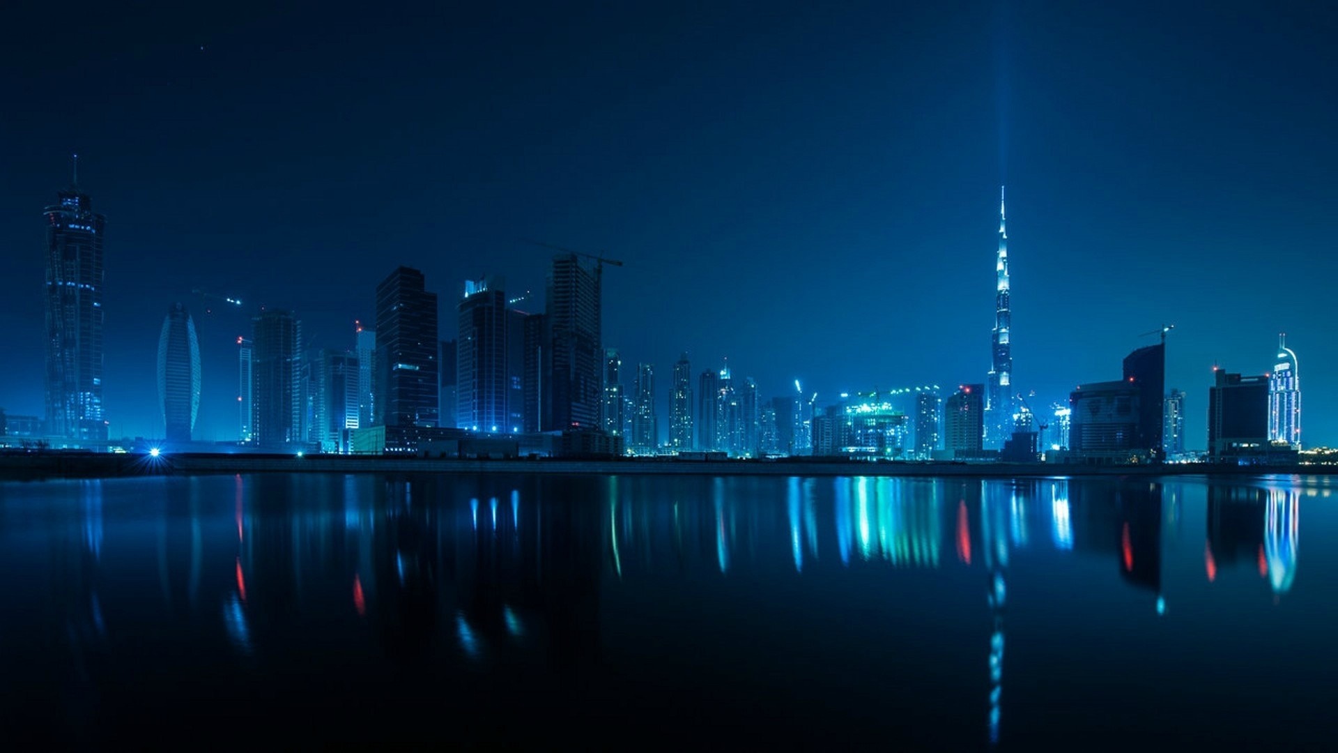 Dubai skyline at night with reflections HD Wallpaper