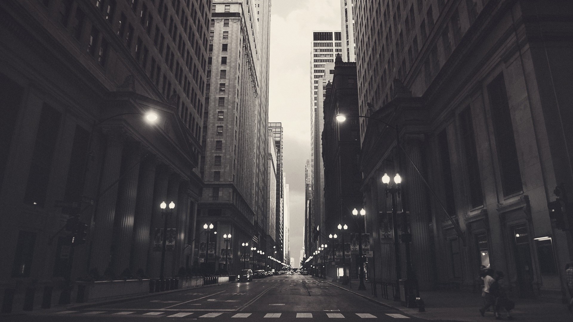 Monochrome city street with skyscrapers and streetlights HD Wallpaper