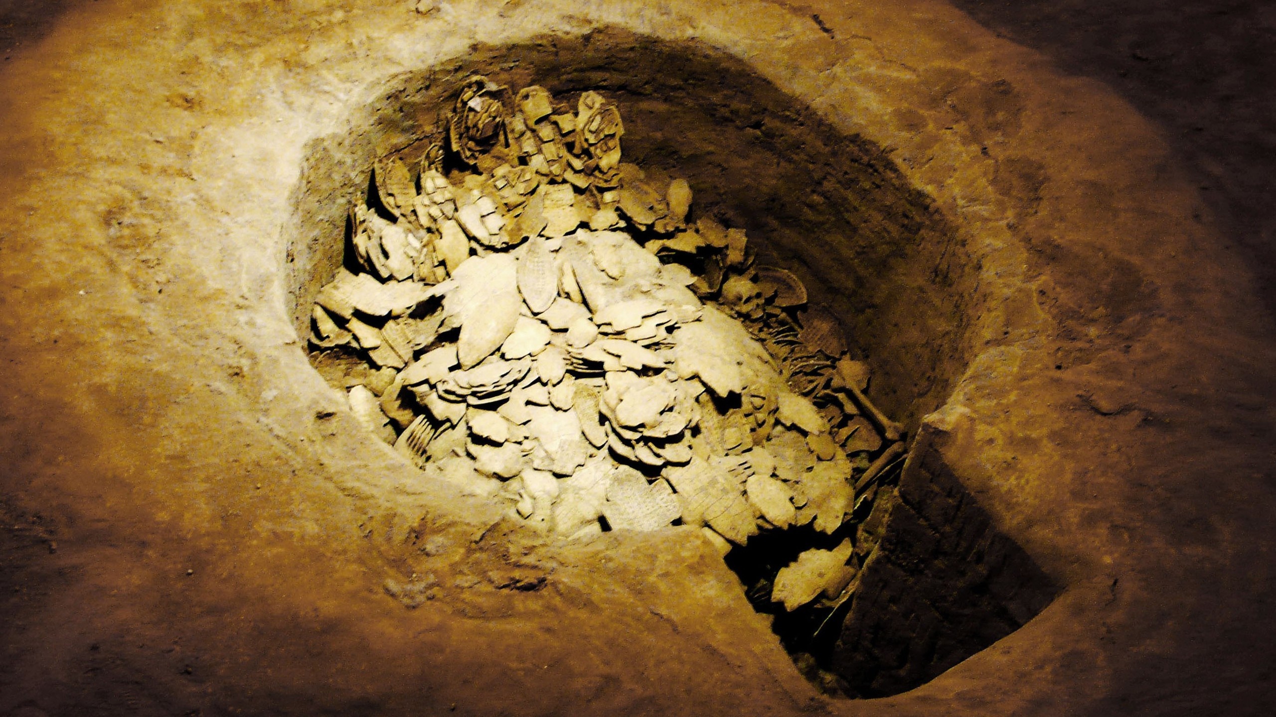 Archaeological excavation of ancient burial site with artifacts HD Wallpaper
