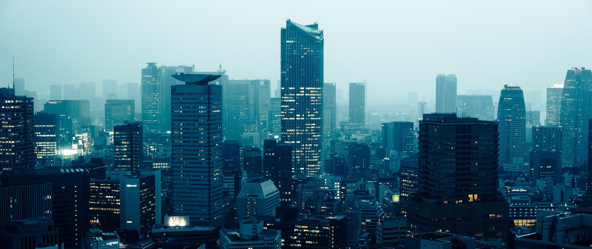Cityscape at dusk with illuminated skyscrapers HD Wallpaper
