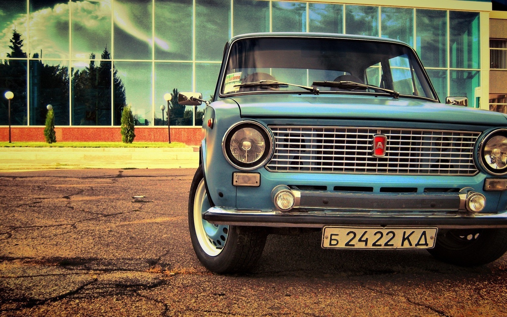 Blue LADA classic car parked in front of a modern building HD Wallpaper