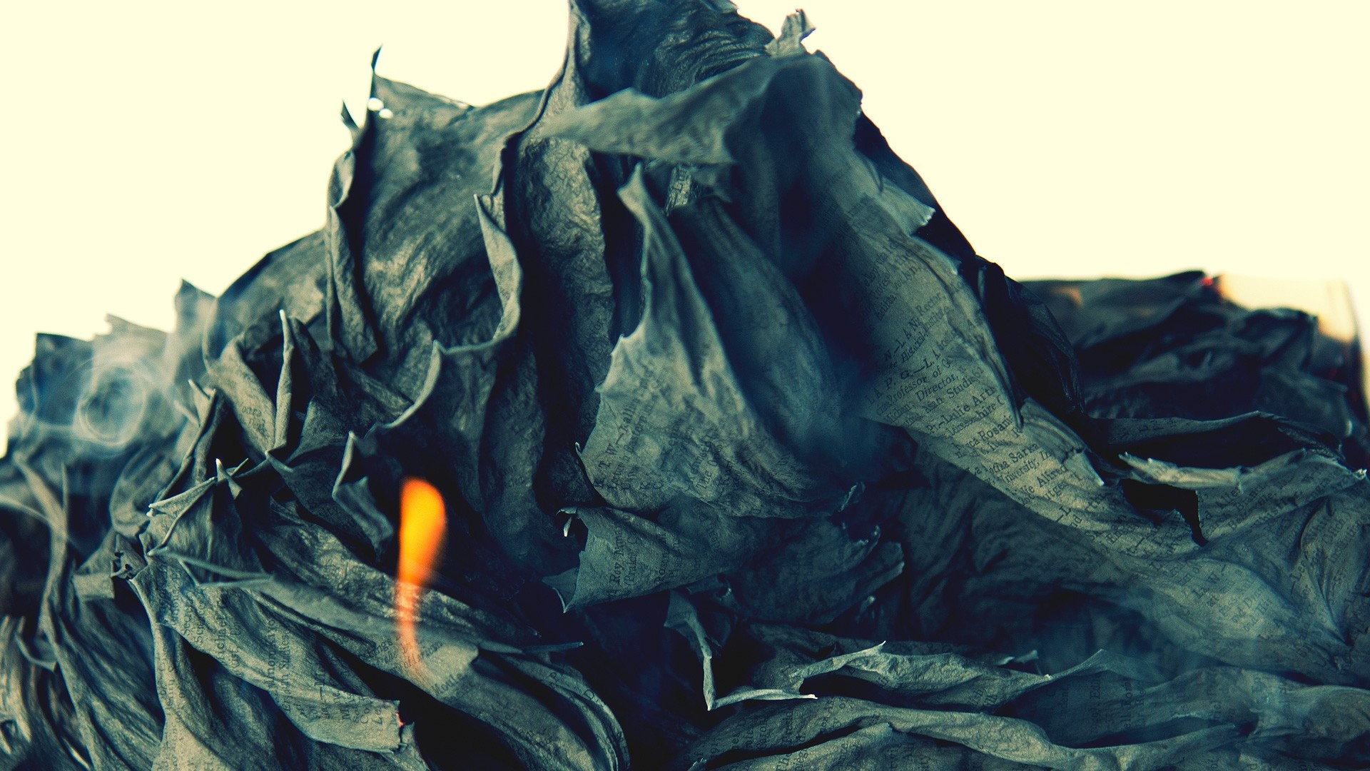 Burning crumpled paper with text HD Wallpaper