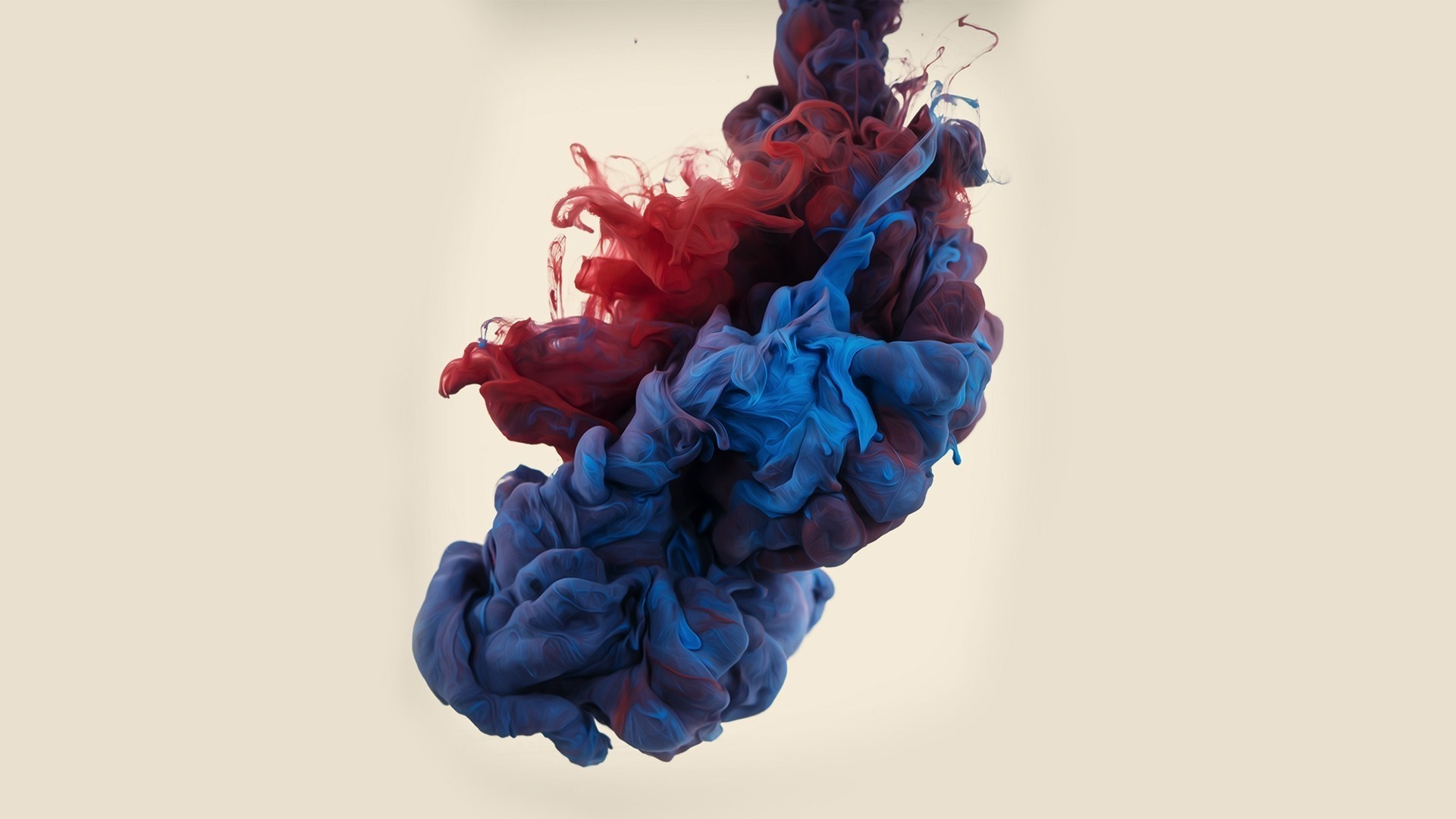 Red and blue ink swirling in water HD Wallpaper