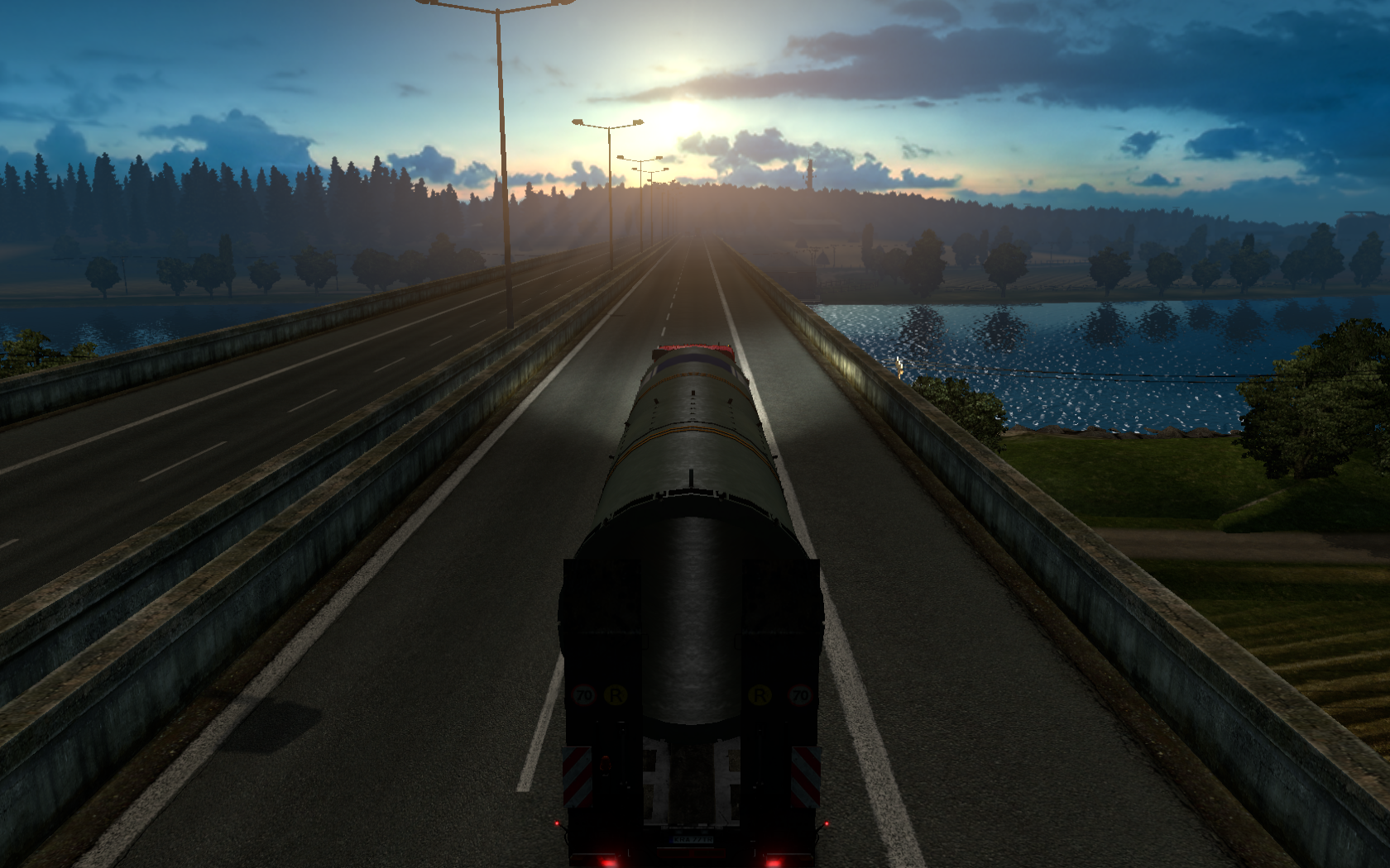 Truck driving on a highway at sunset in Euro Truck Simulator 2 HD Wallpaper
