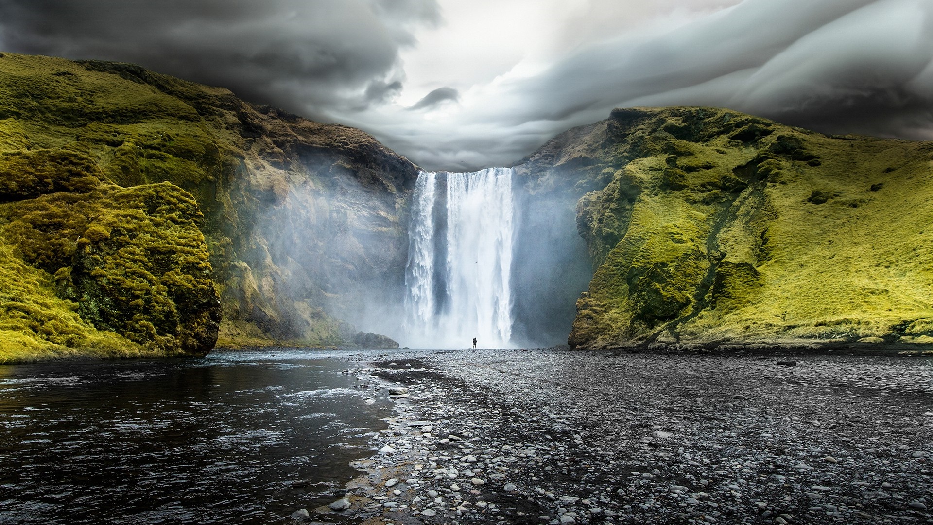 Skogafoss Waterfall in Iceland with a lone figure HD Wallpaper