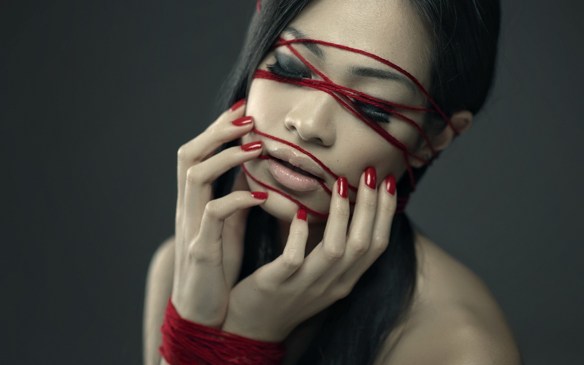Woman with red yarn on face and hands HD Wallpaper