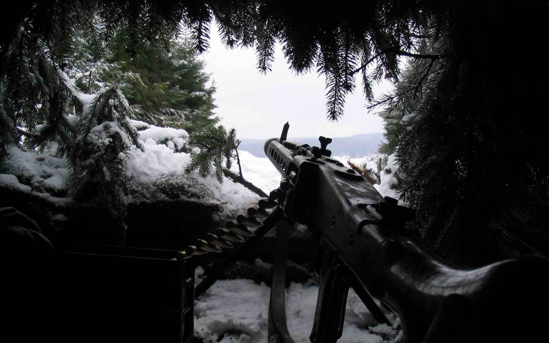 Machine gun in a snowy forest setting HD Wallpaper