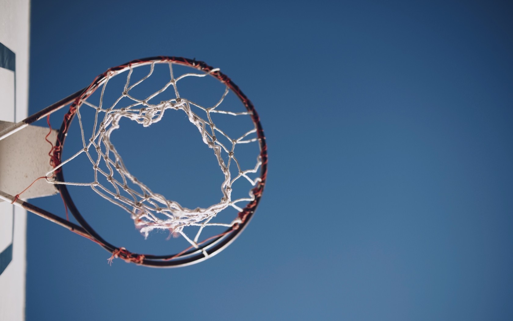 Basketball hoop against a clear blue sky HD Wallpaper