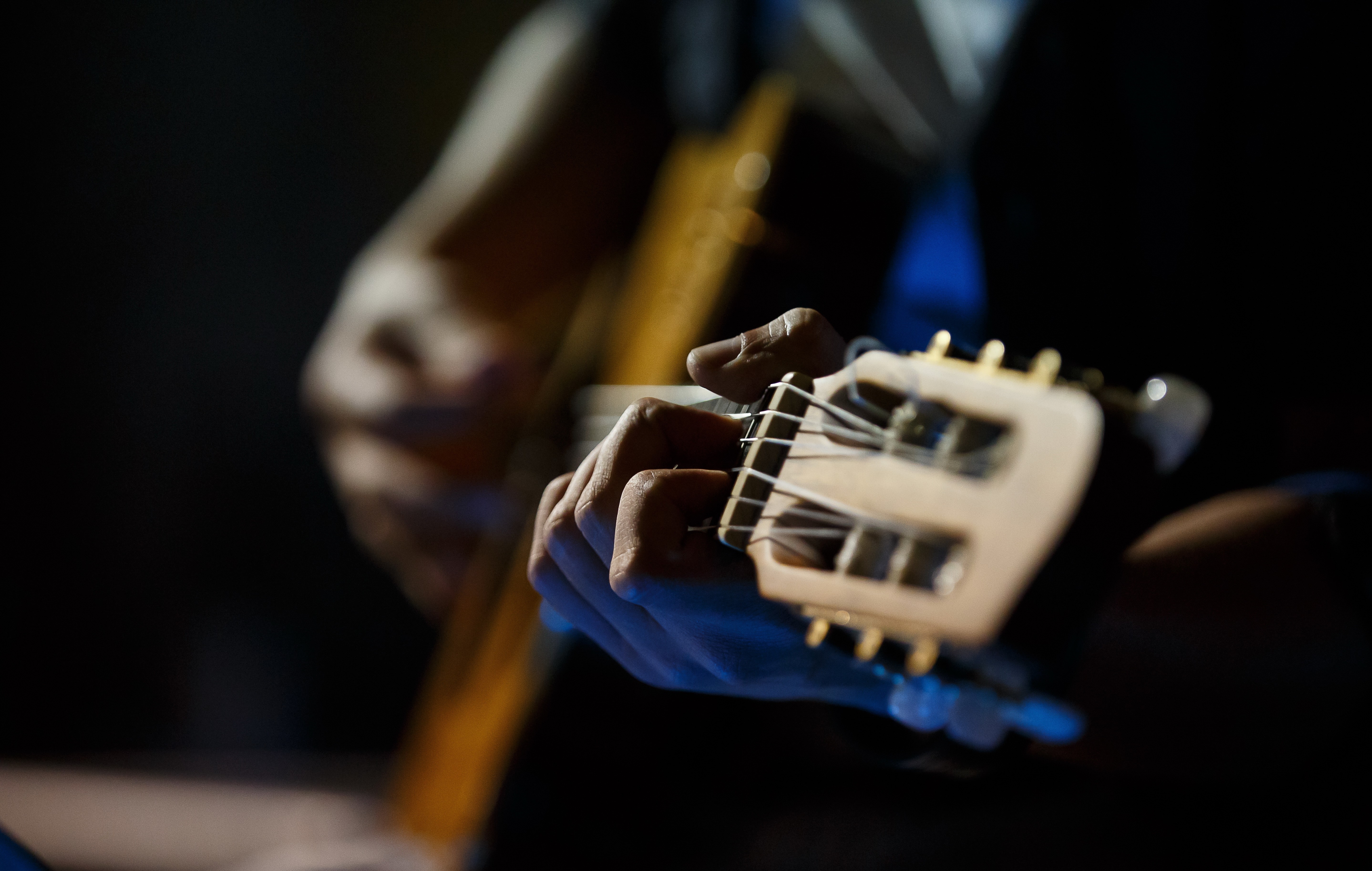 Close-up of a person playing a guitar HD Wallpaper
