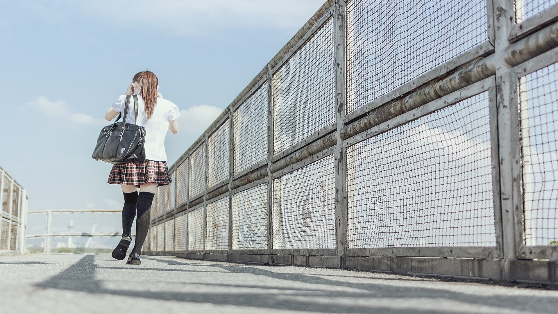 Schoolgirl with bag walking on a walkway HD Wallpaper
