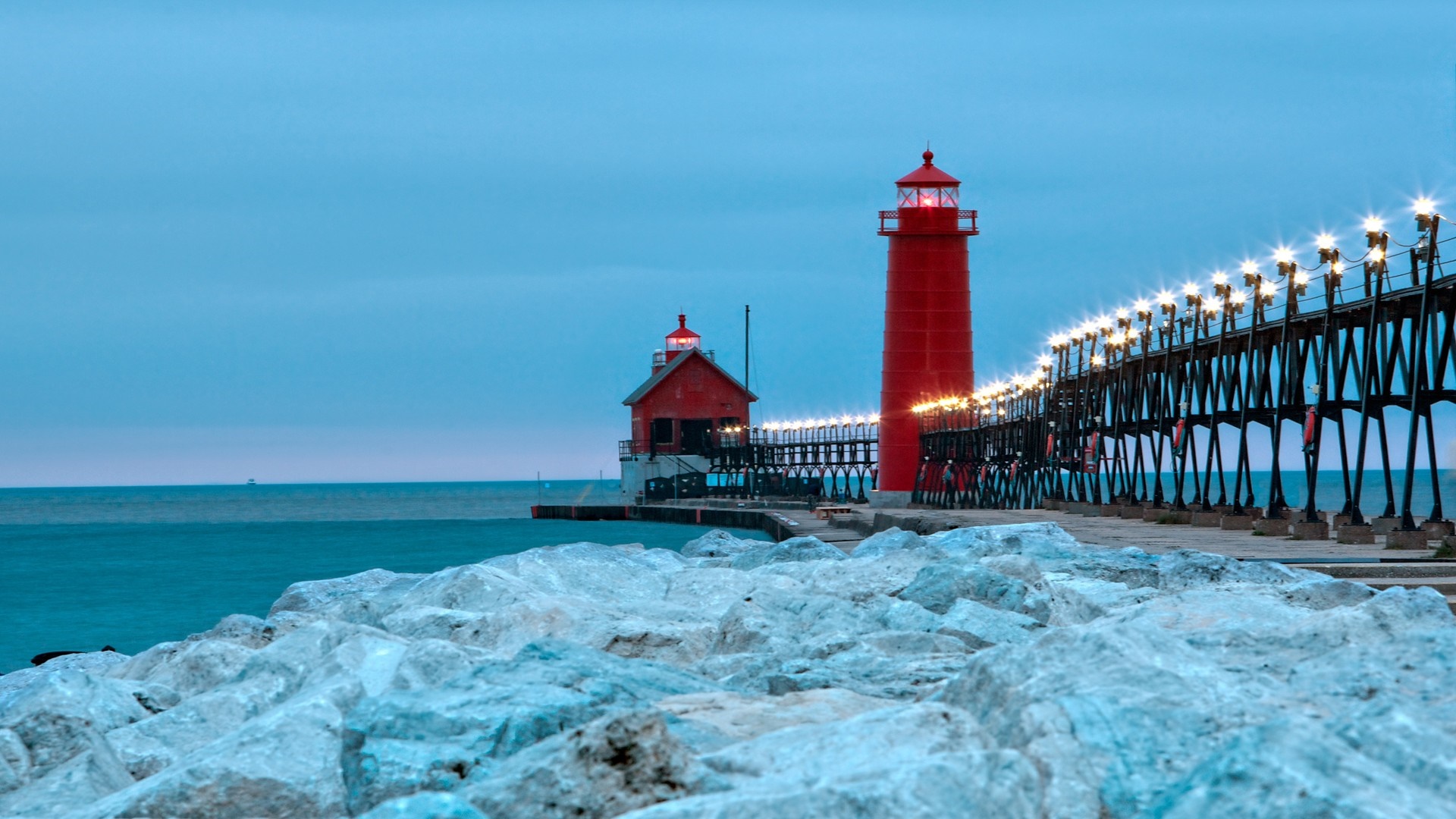 Two red lighthouses and a pier at dusk HD Wallpaper
