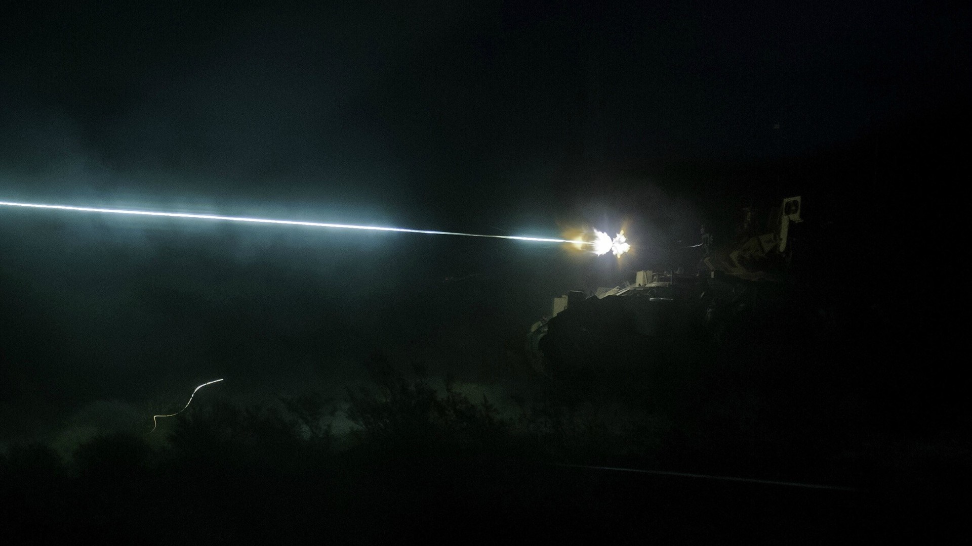 Bradley Fighting Vehicle firing a laser at night HD Wallpaper