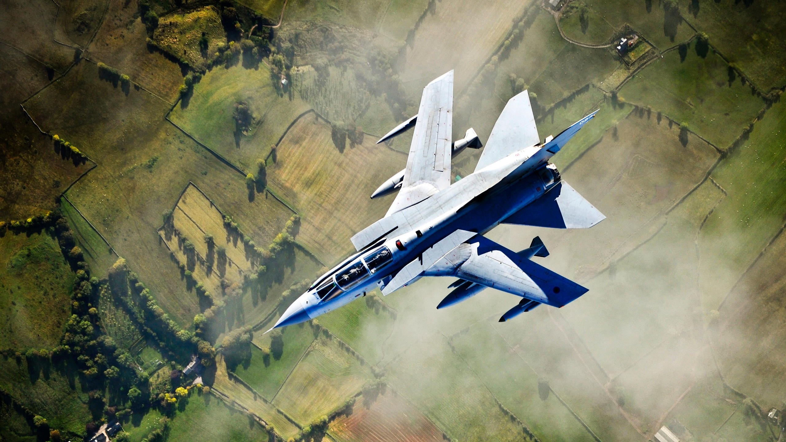 Panavia Tornado fighter jet flying over rural landscape HD Wallpaper